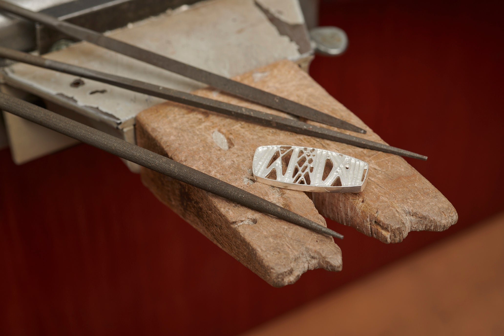 A close up of a silver item from the Ness of Brodgar Collection sitting on the workbech