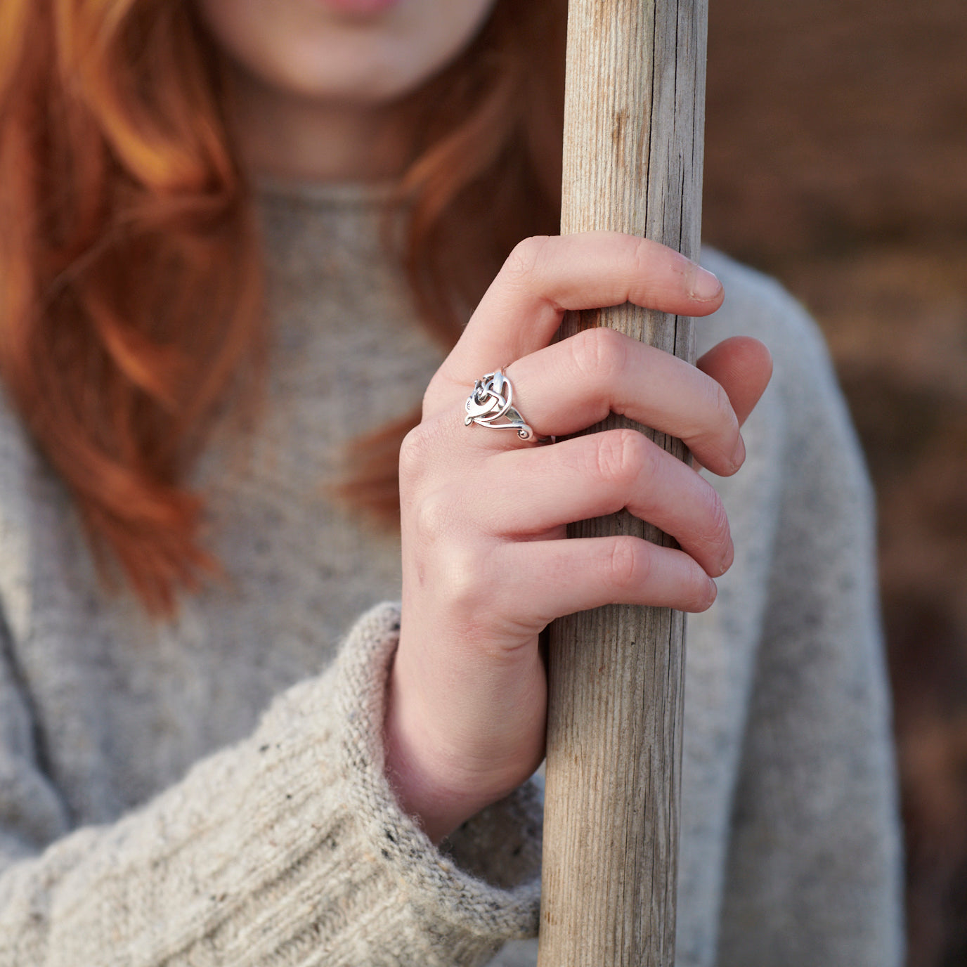 close up of woman in heather wearing finnish beast ring