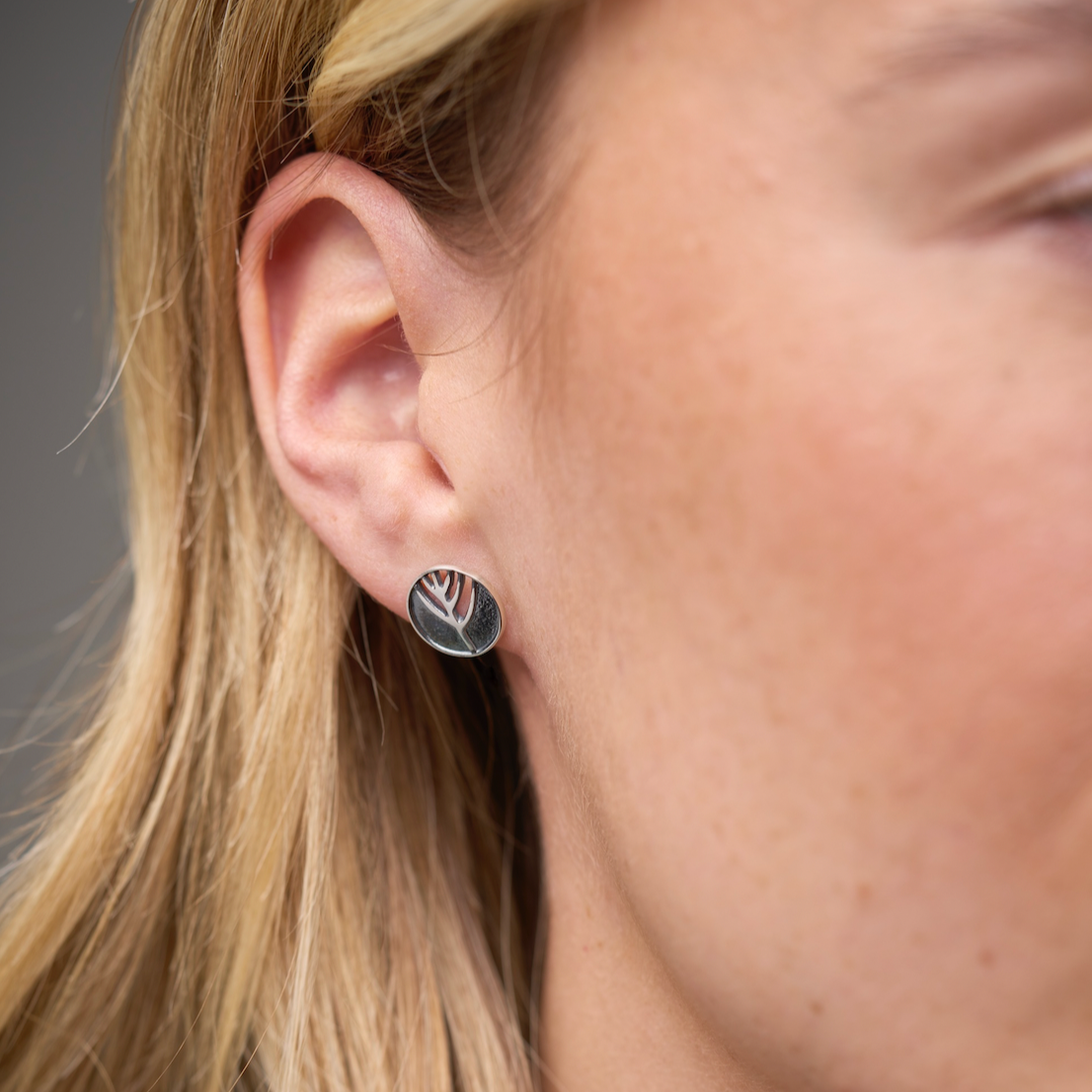 Woman with circular studded earring