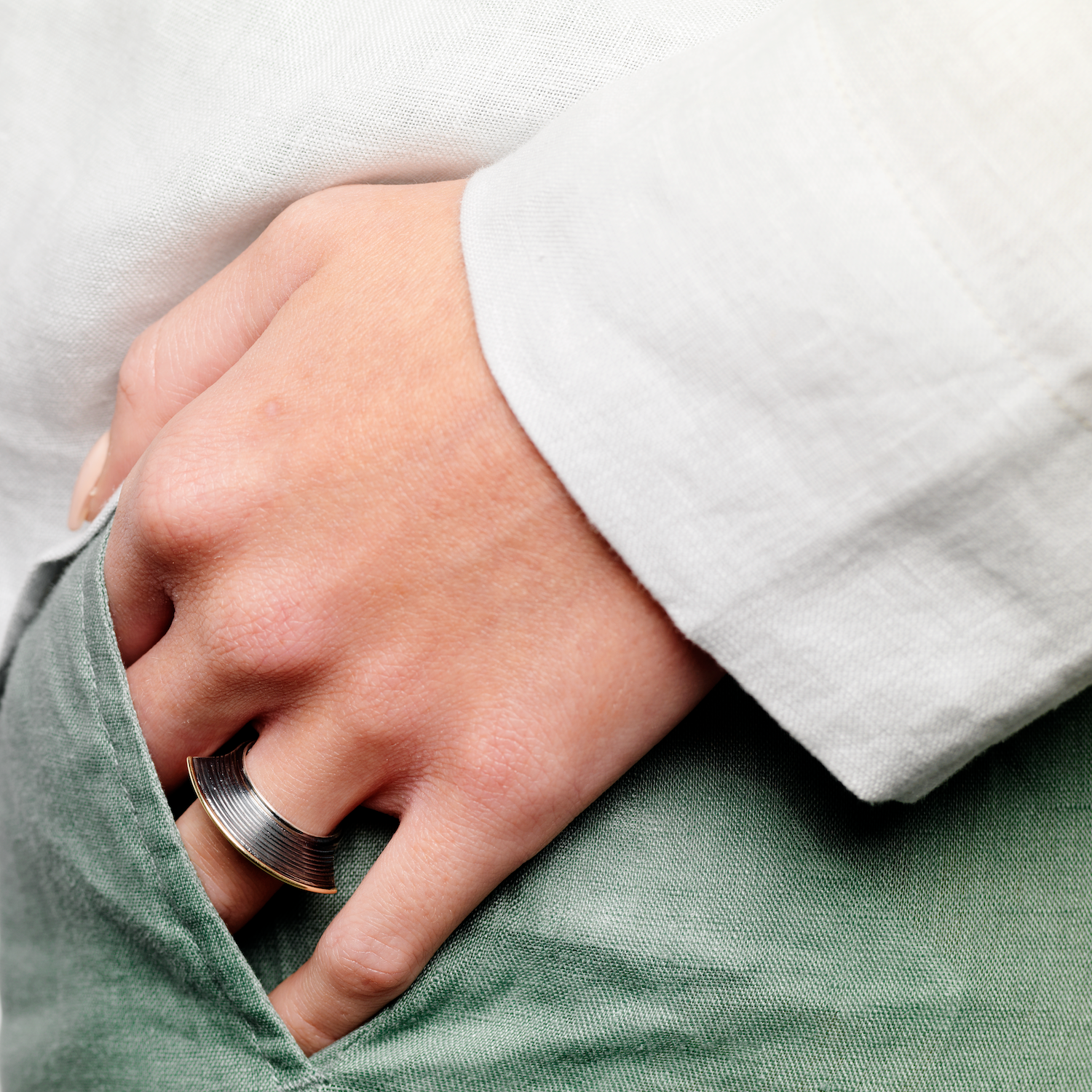 woman with hand in pocket with ring