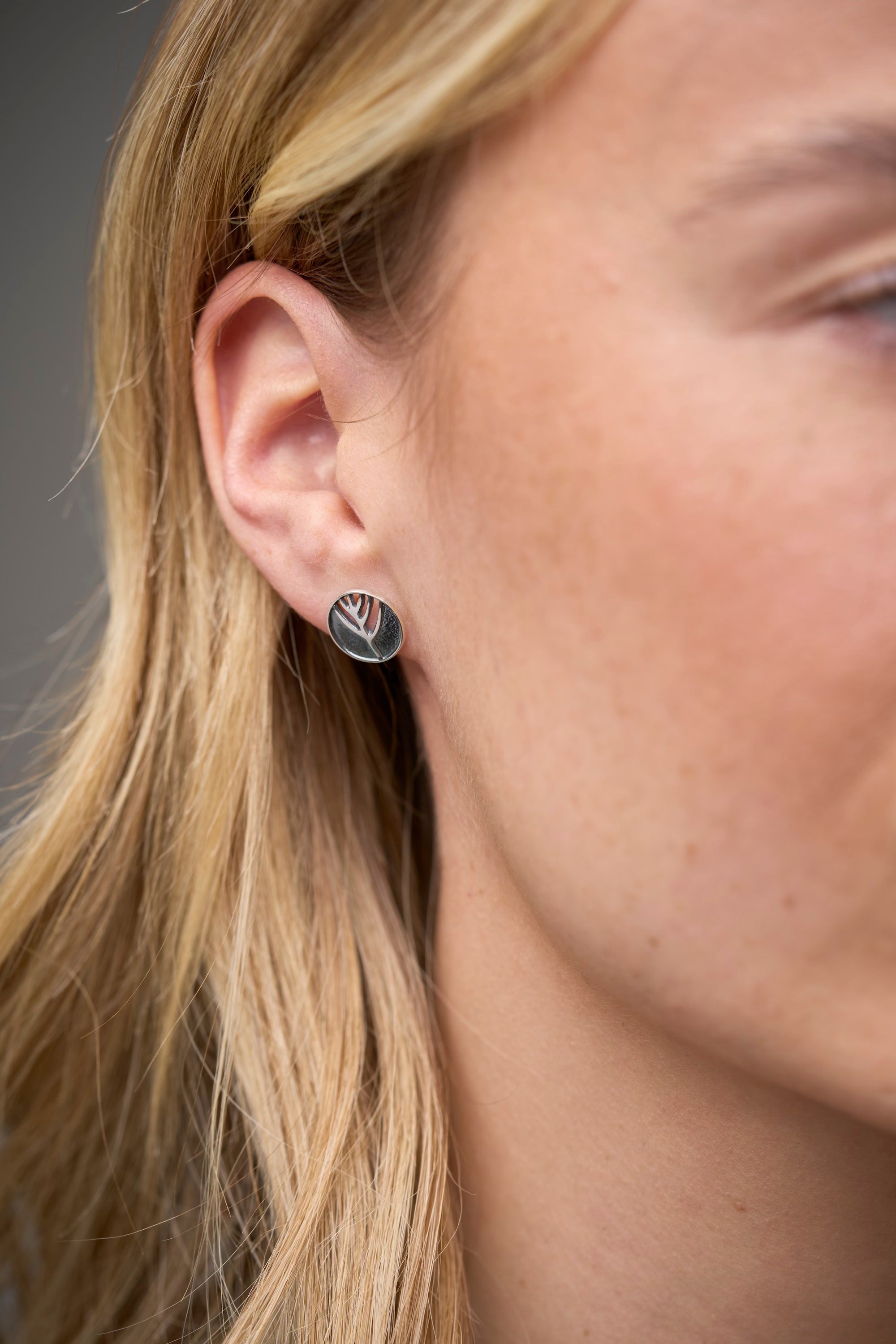 woman with circular stud earring