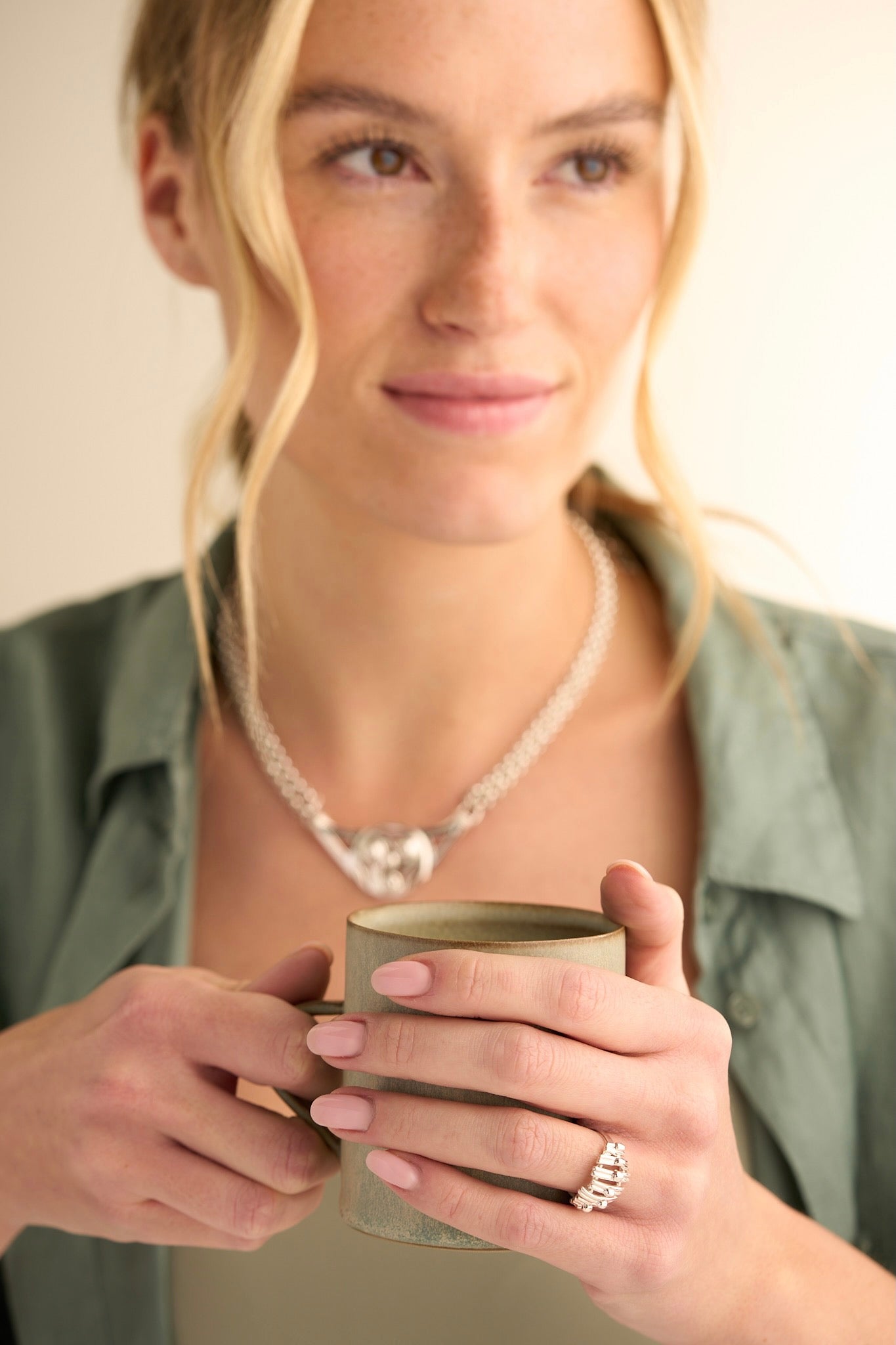 Blurred woman with necklace and ring