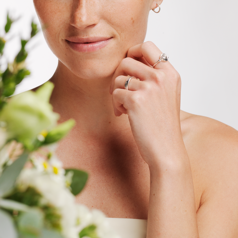 Model wearing Ola Gorie silver Rose ring, and other jewellery