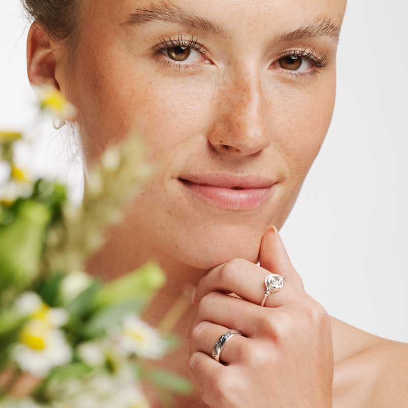 Model wearing Ola Gorie silver Rose ring, and other jewellery