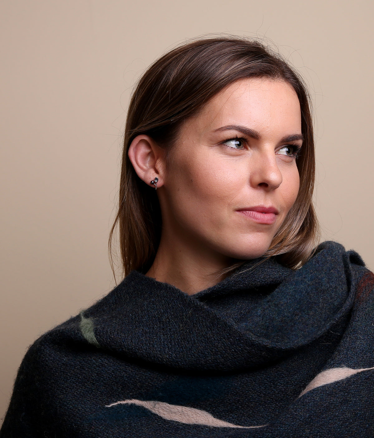 Woman in black top models silver drop earring from the Cloudberry Collection