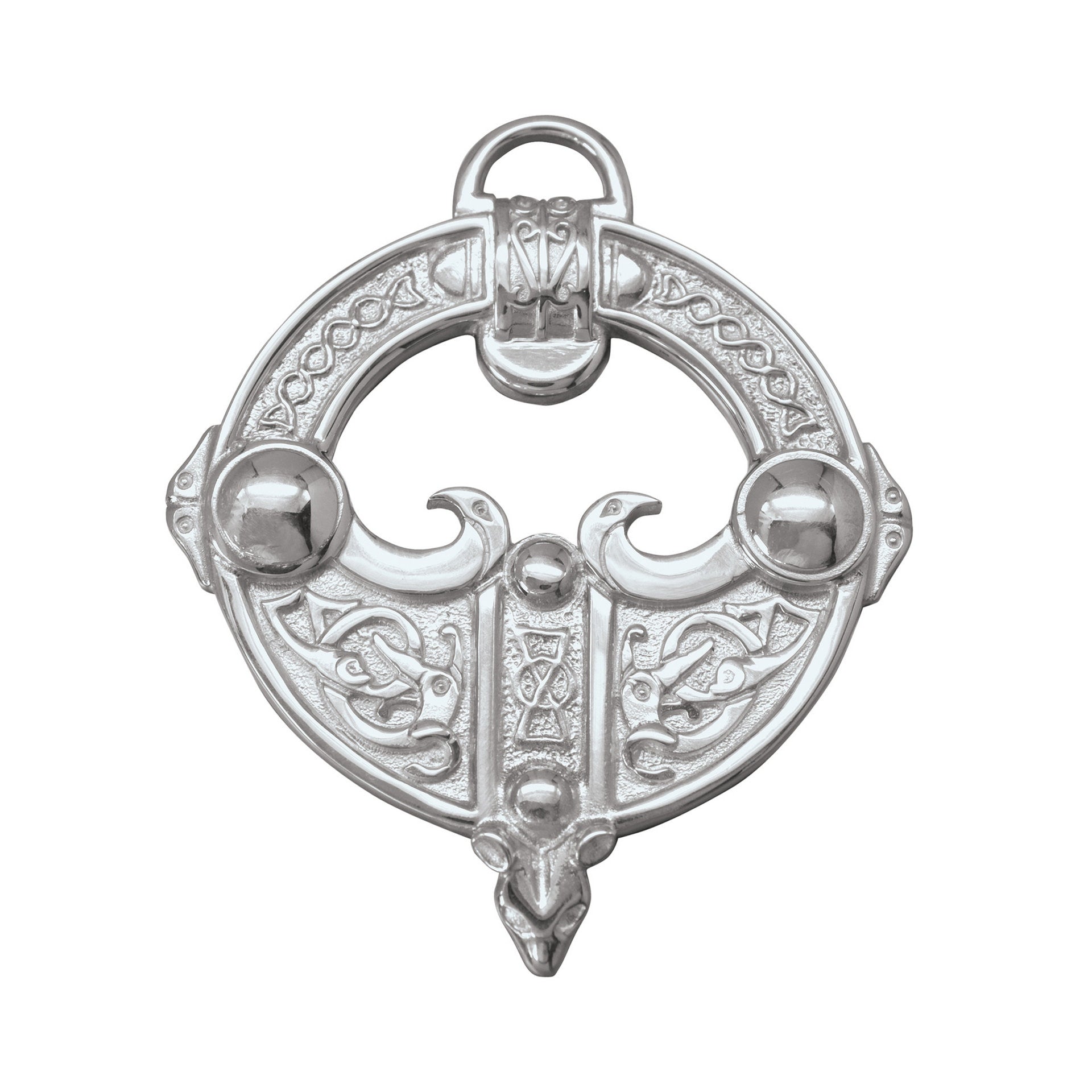 A silver brooch with a intricate celtic design