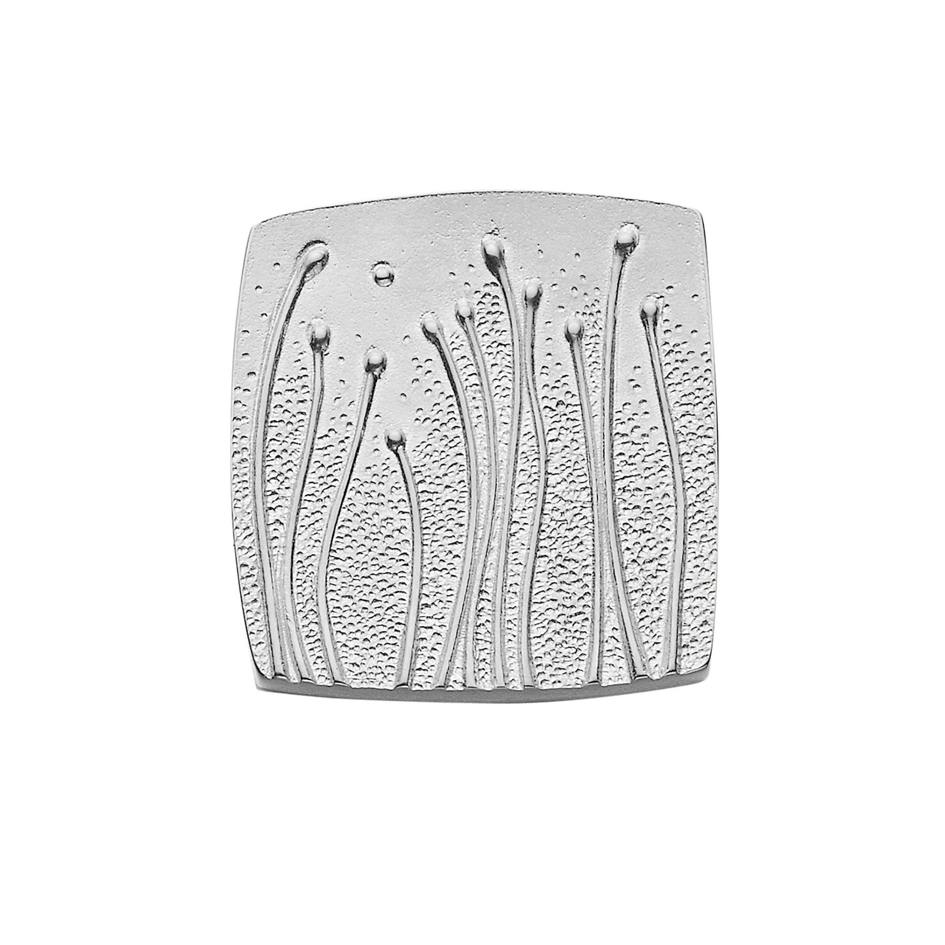 A square silver brooch with detailed plant design from the Machair Collection