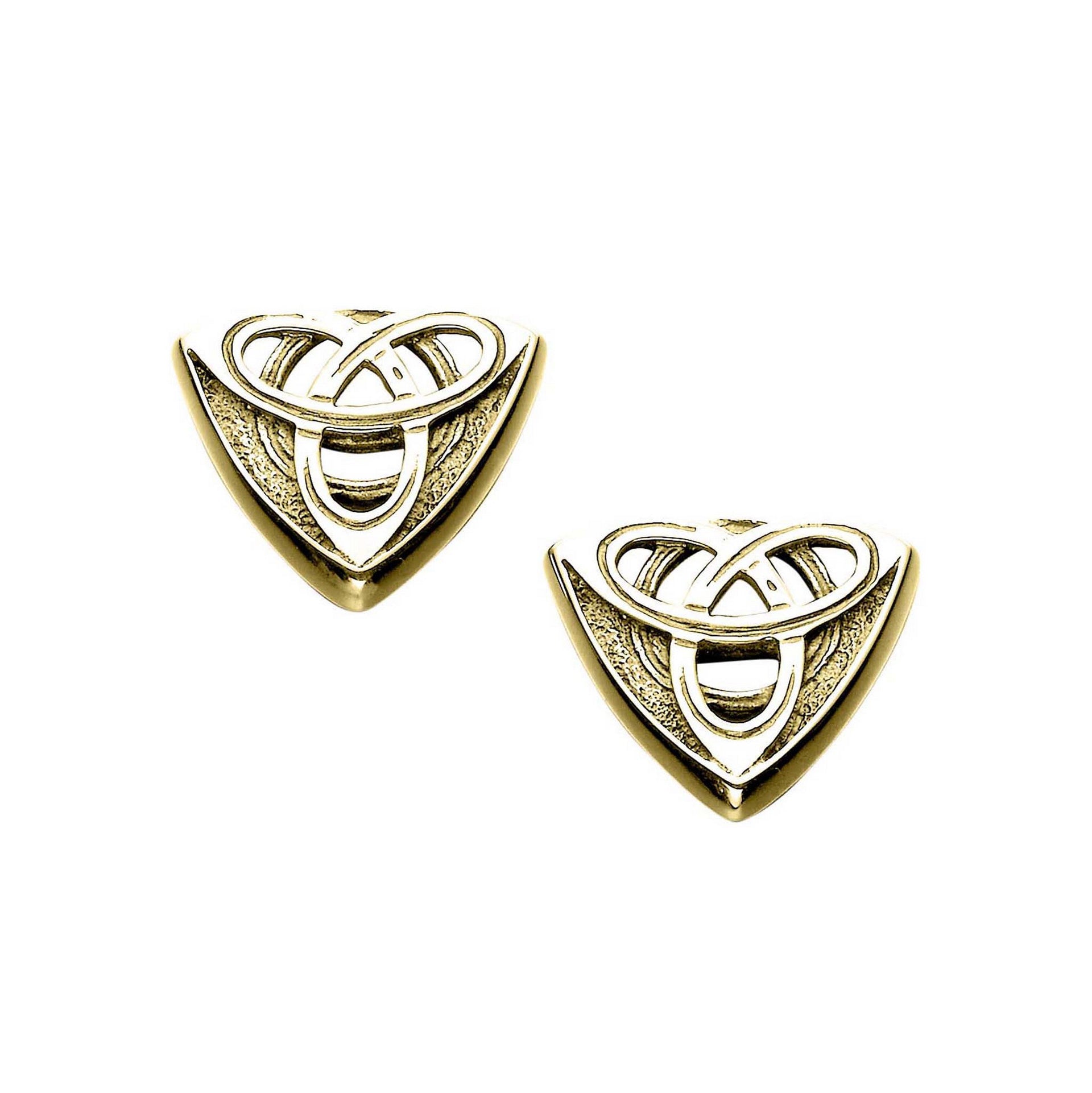 A pair of gold cuff links with an intricate geometric celtic design