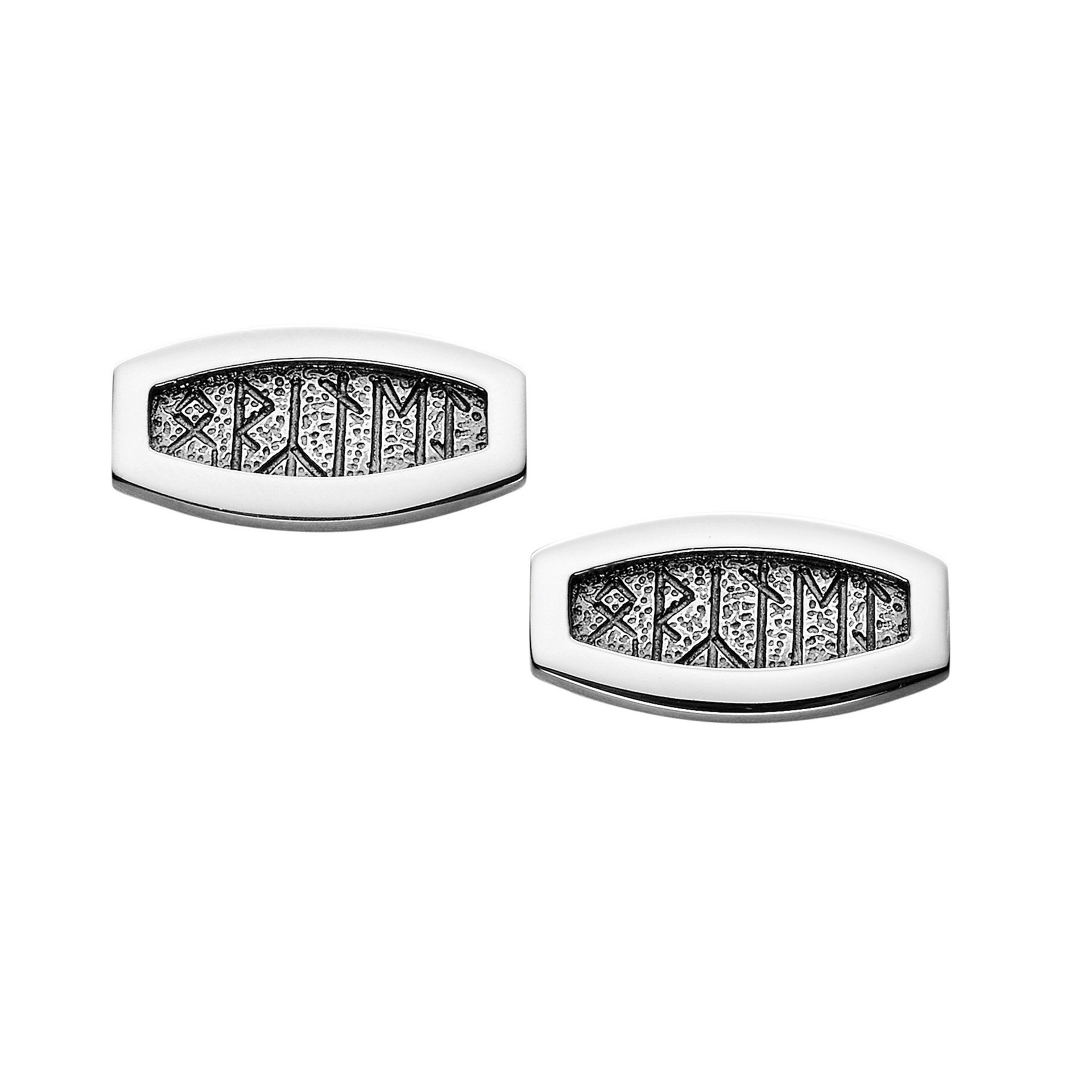 A pair of oval silver cuff links with intricate rune details
