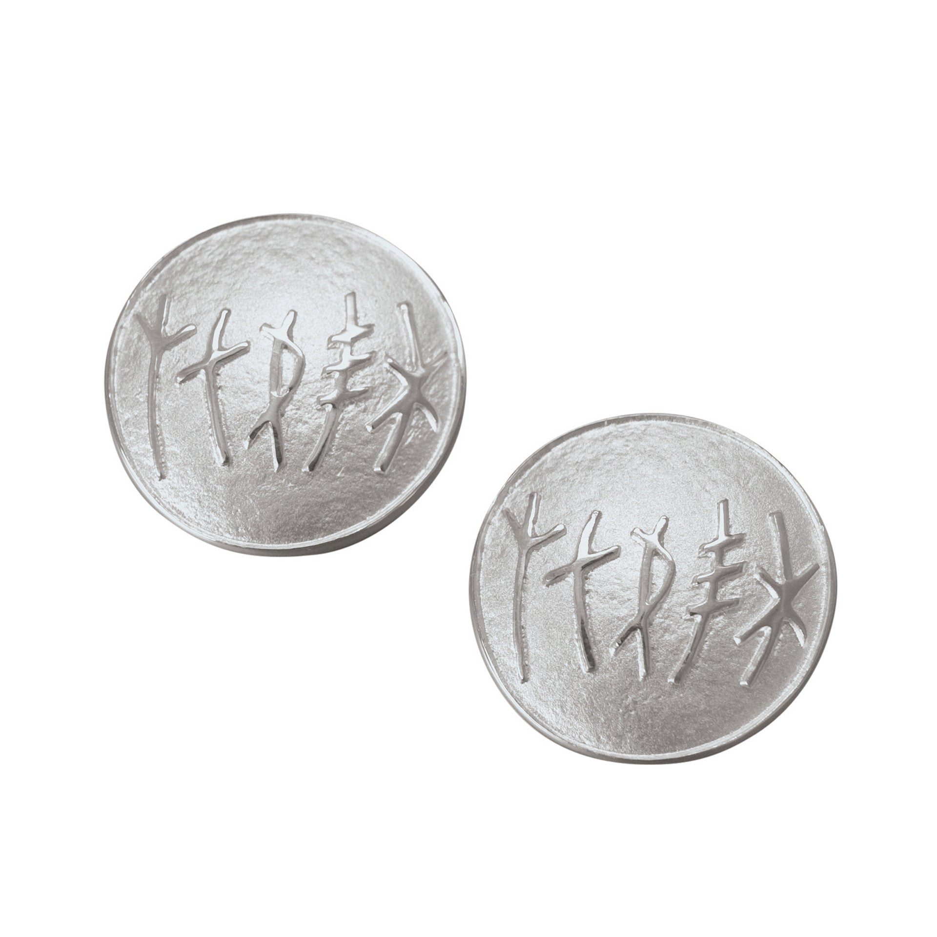 A pair of circular silver cuff links with a simple rune design