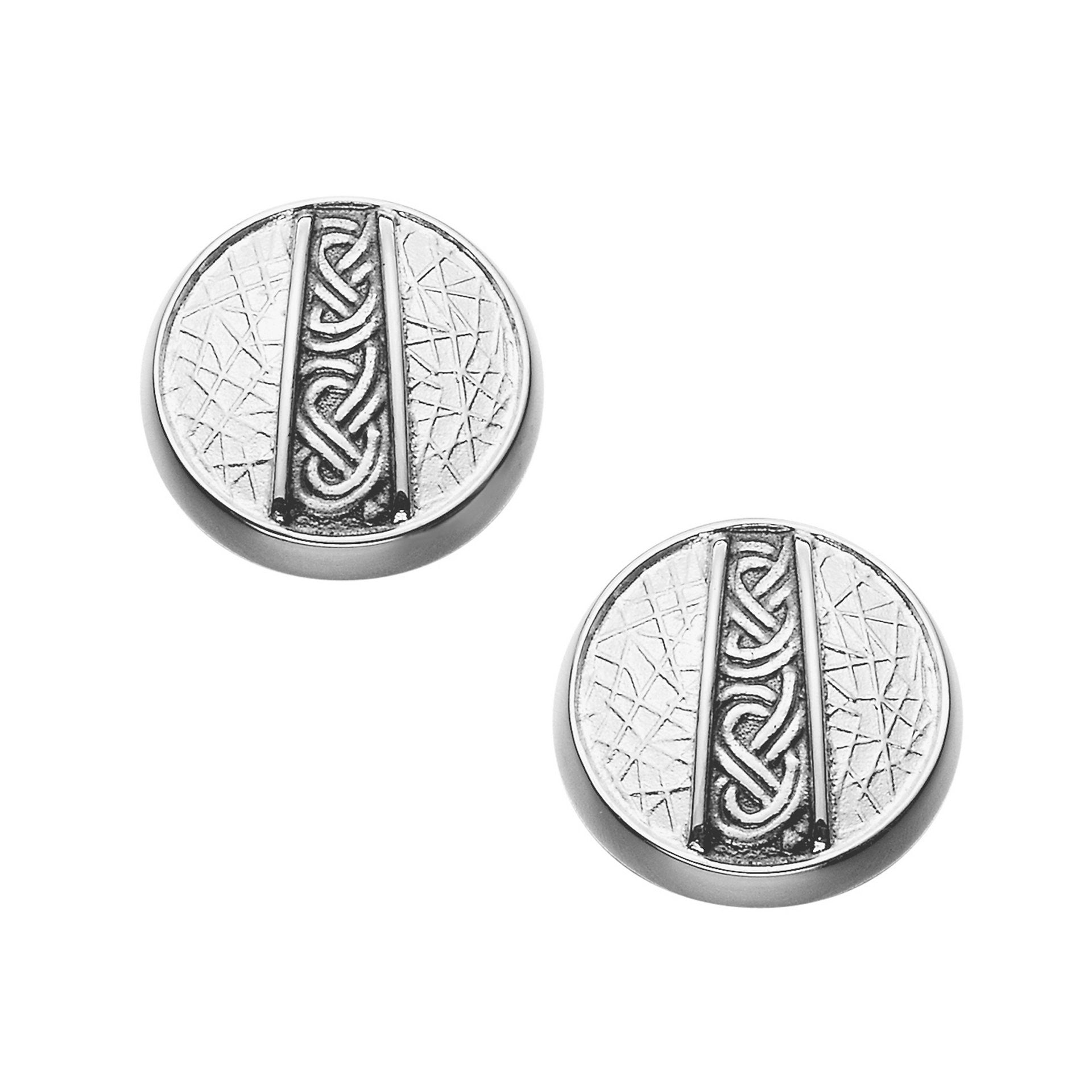 A pair of circle silver cuff links with intricate texture and celtic design
