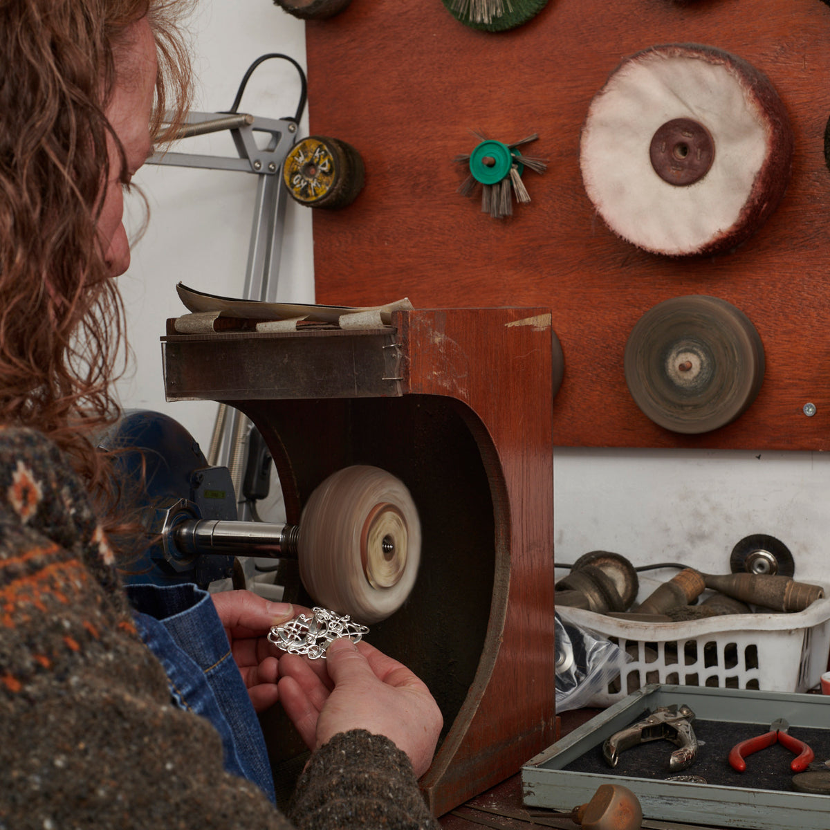 A piece of jewellery is being pollished