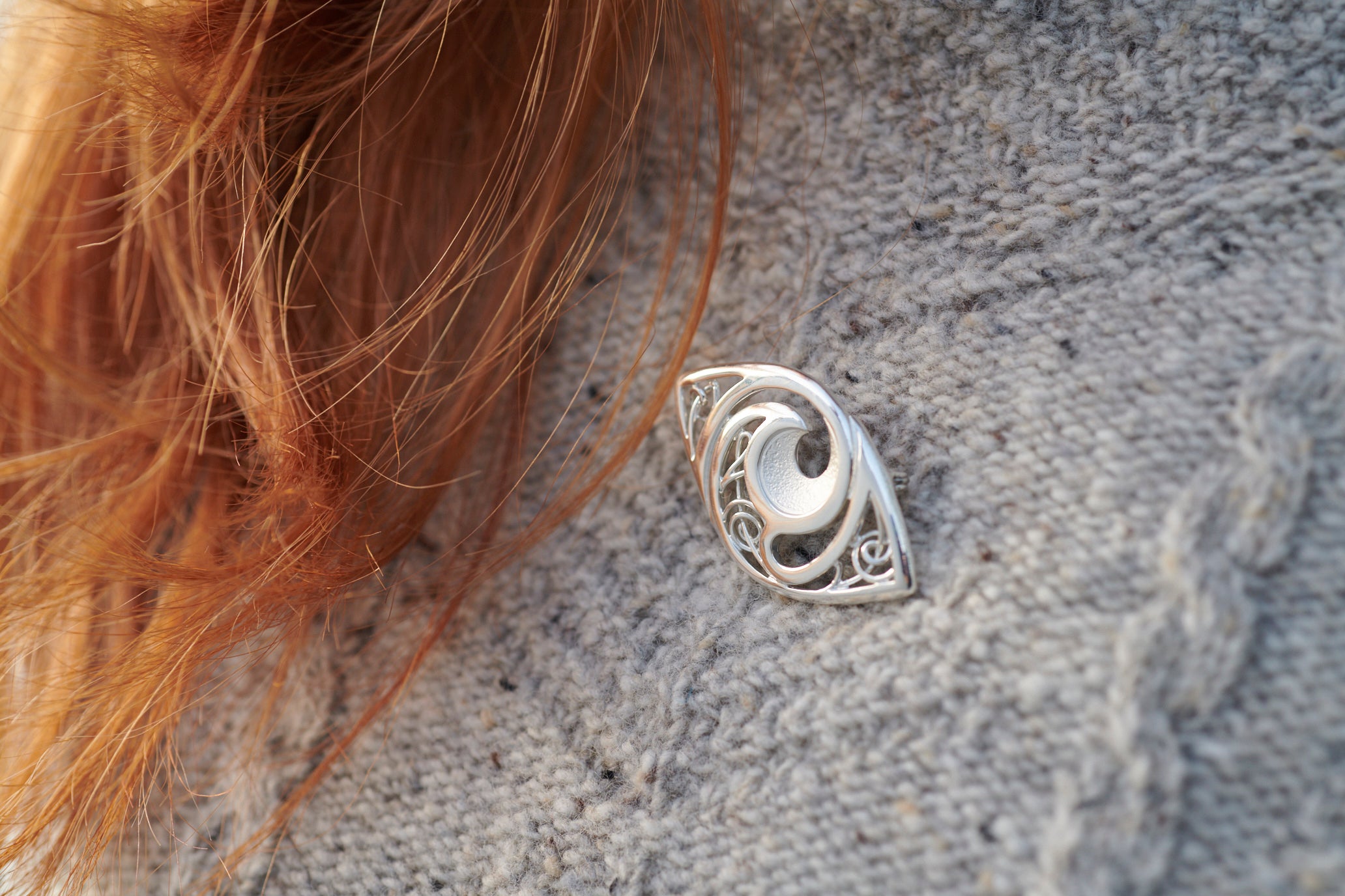 Close up of woman wearing silver Evie brooch