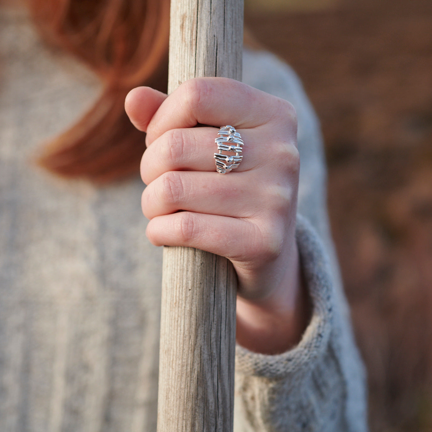 Close up of woman wearing silver Broch ring