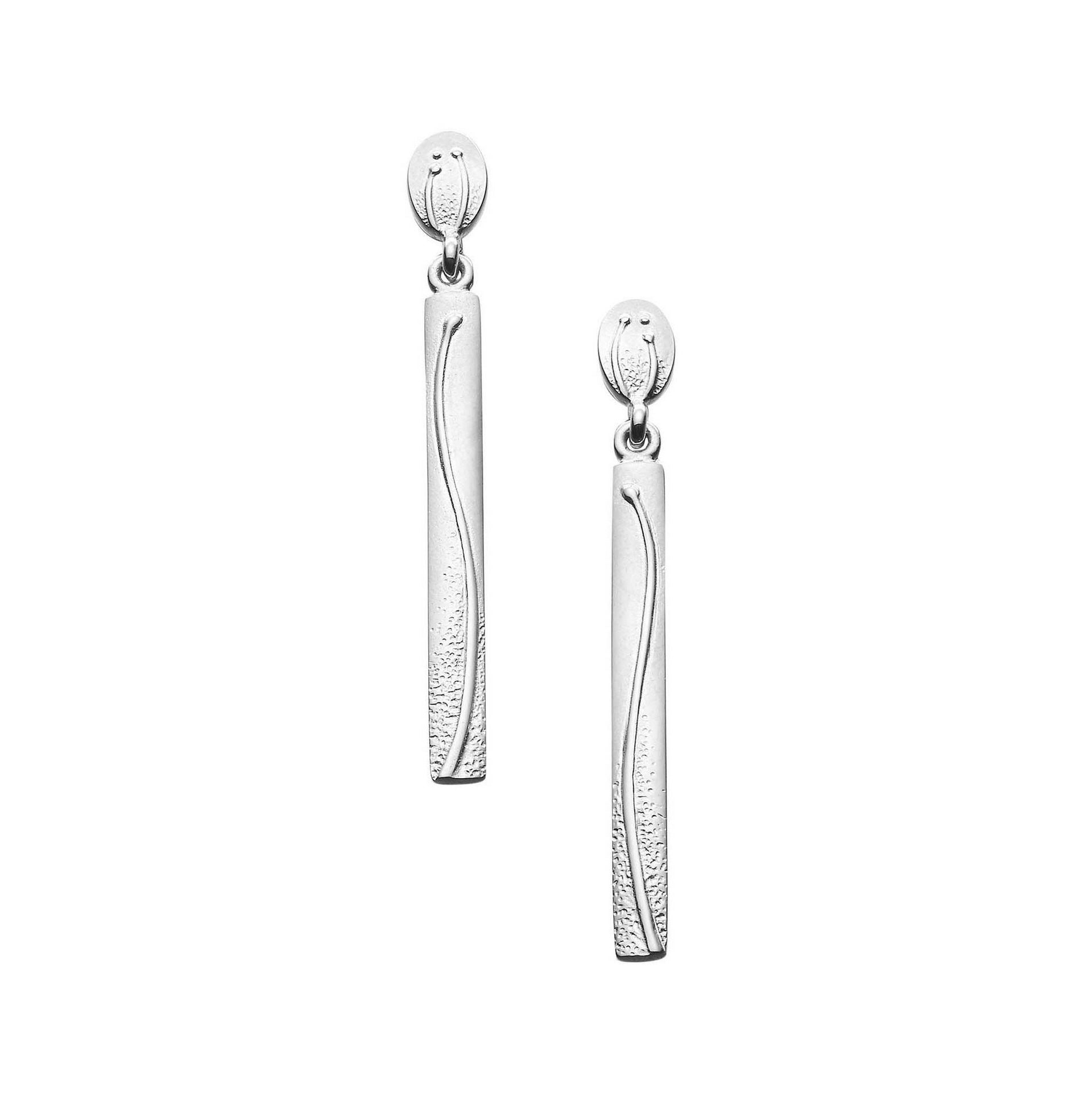 A pair of oval and pendant silver drop earrings with a flower design from the Machair Collection