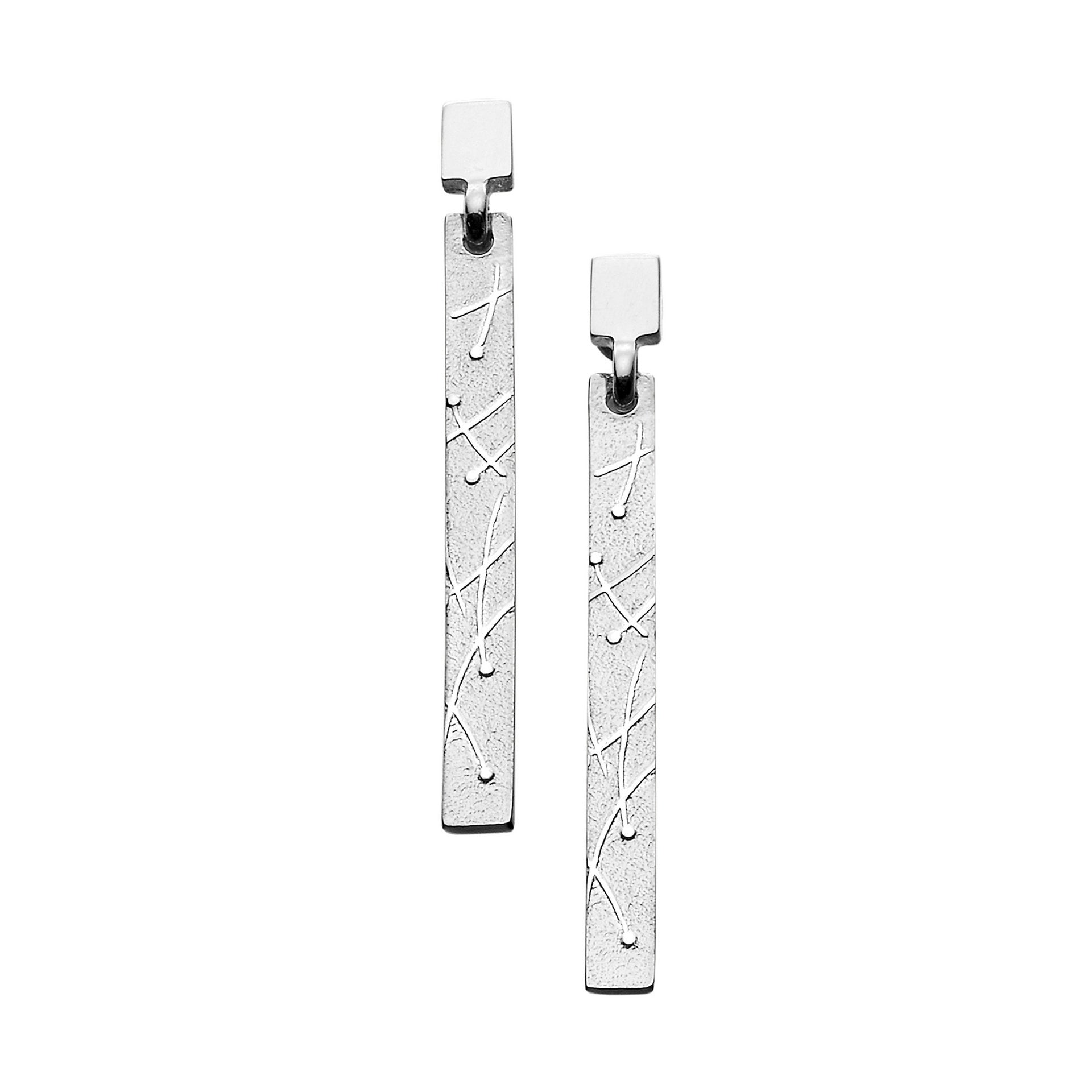 A pair of long silver drop earrings with a modern curved line and dot design