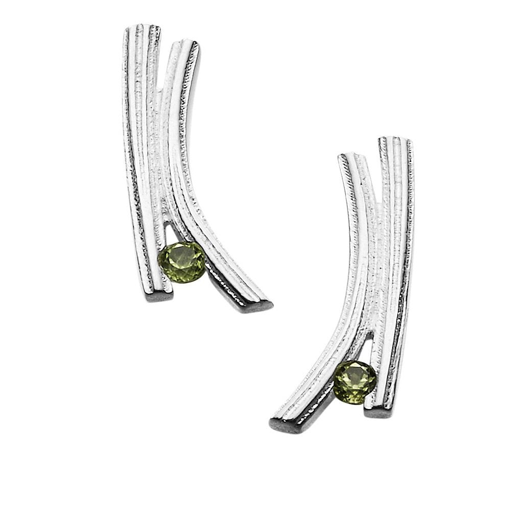 A pair of silver earrings with a contemporary design with a green gem stone at the bottom of each one