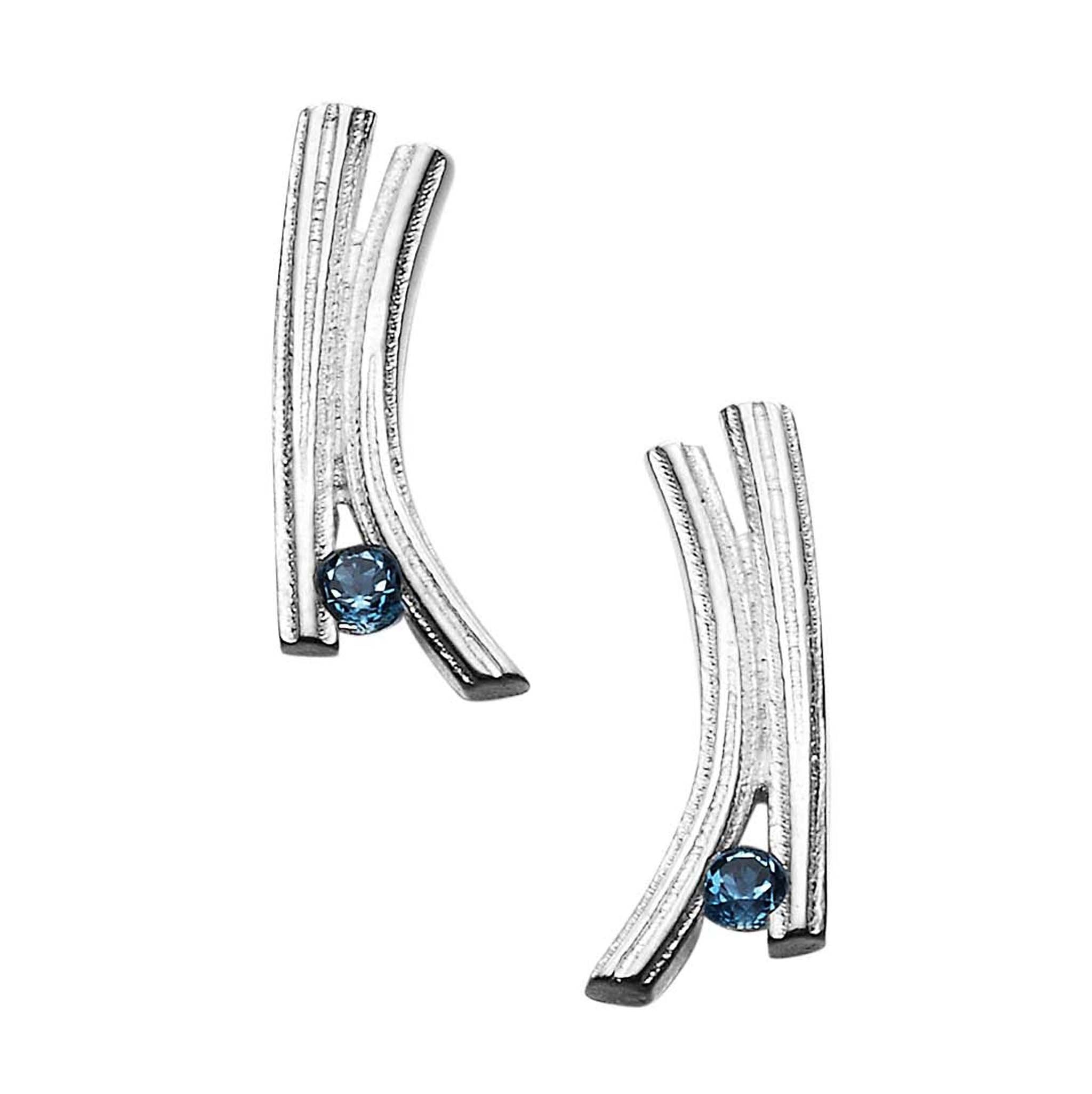 A pair of silver earrings with a contemporary design with a blue gem stone at the bottom of each one