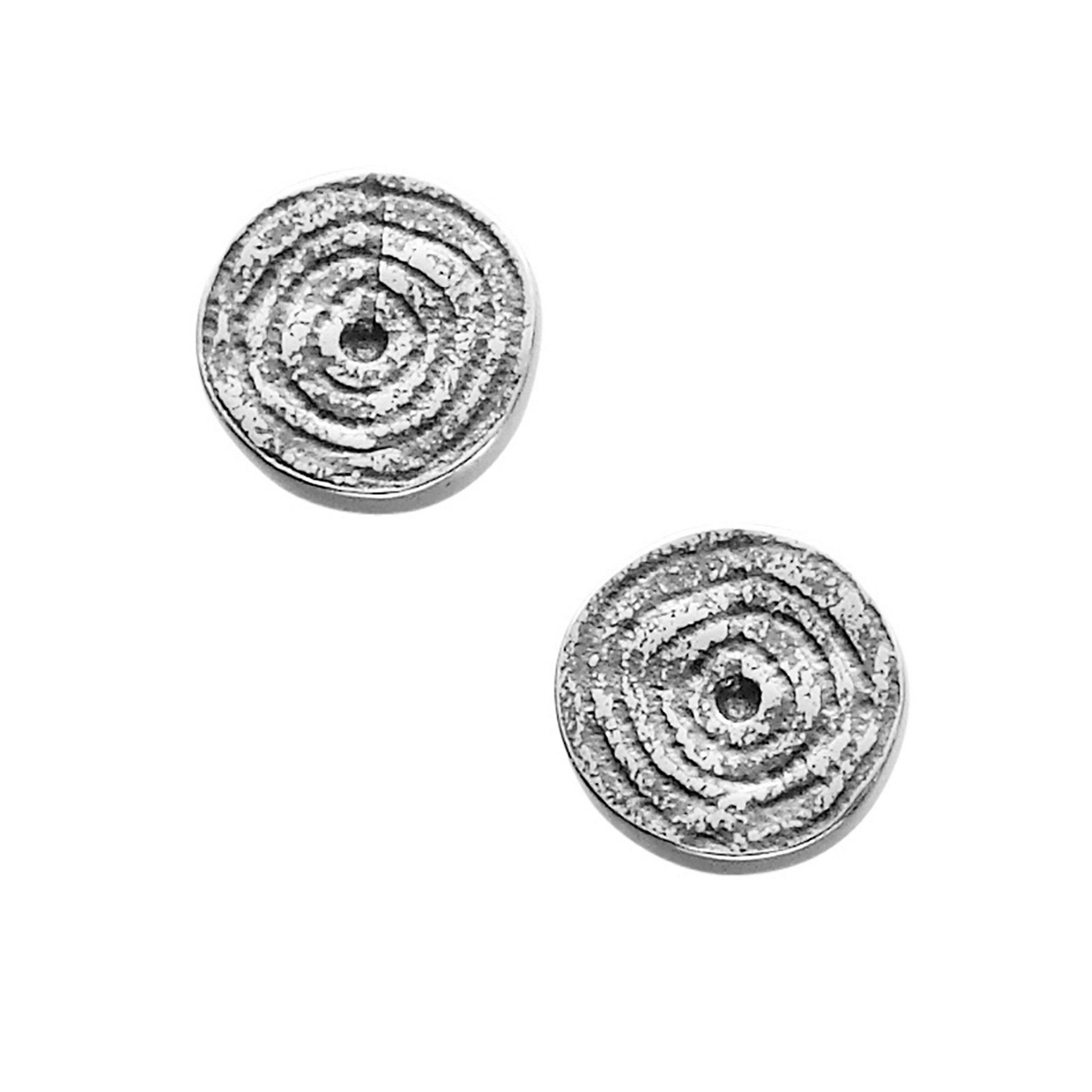 A pair of silver stud earrings with a geometric design from the Kilmartin Collection