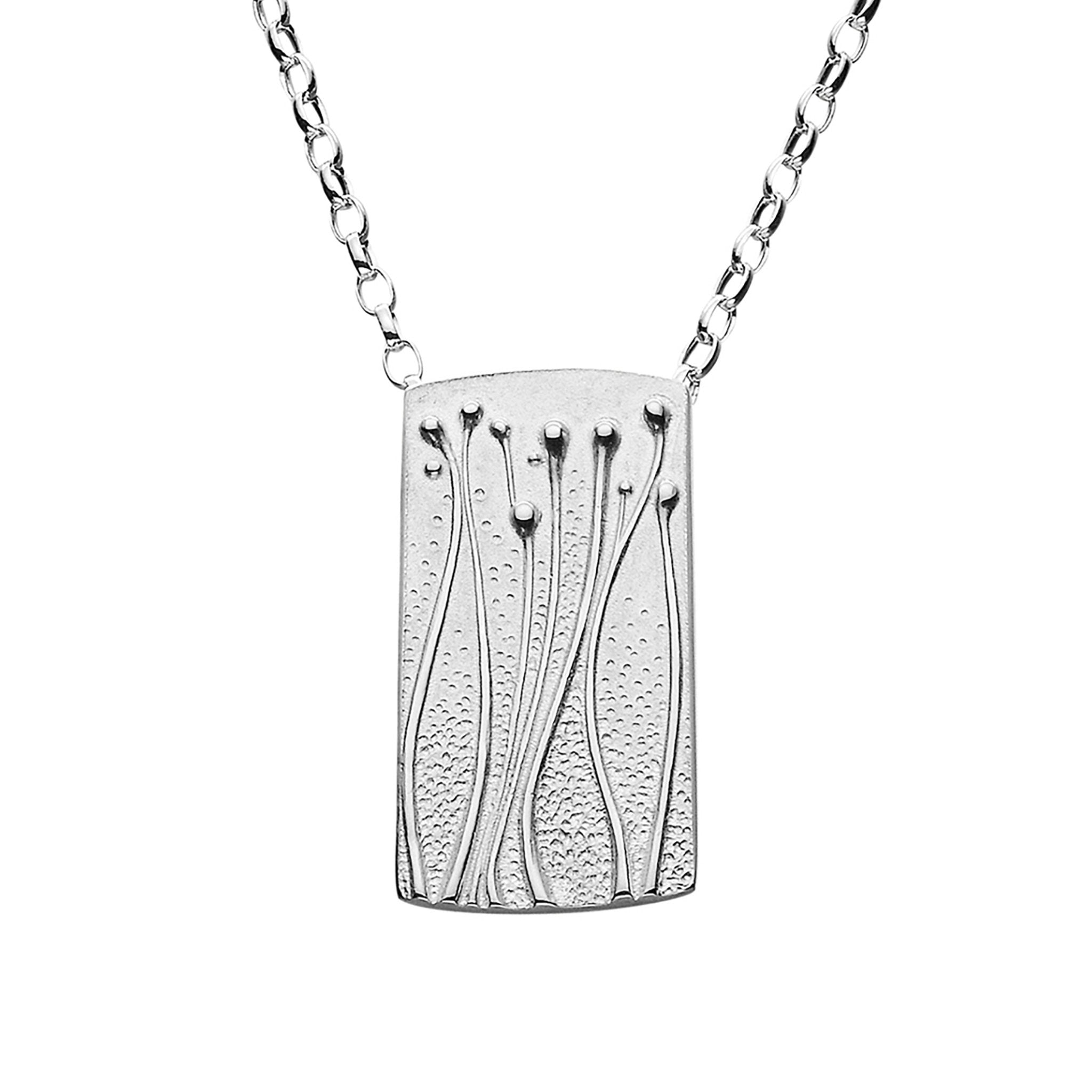 A silver necklace featuring a rectangular pendant with a floral pattern, displayed against a white background.