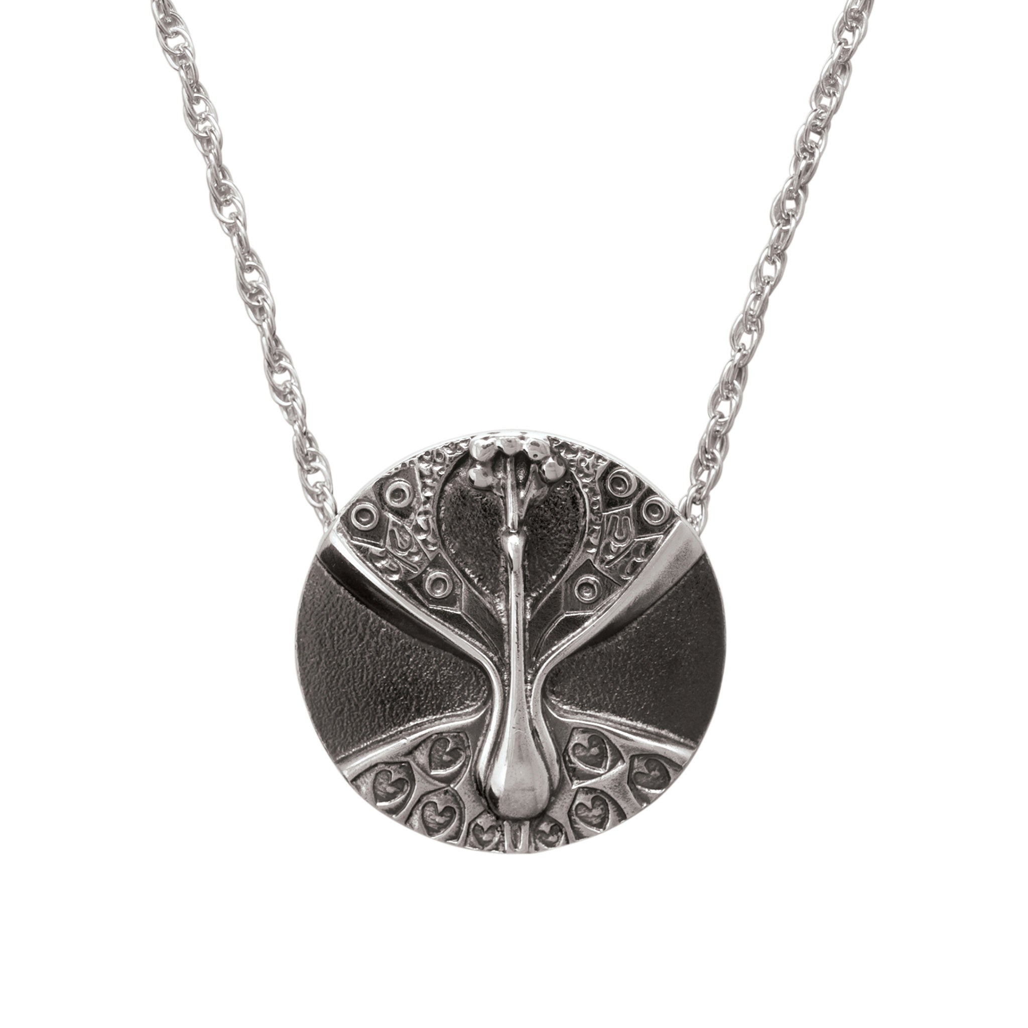 A silver necklace featuring a circular gold pendant with a design of hearts and flowers