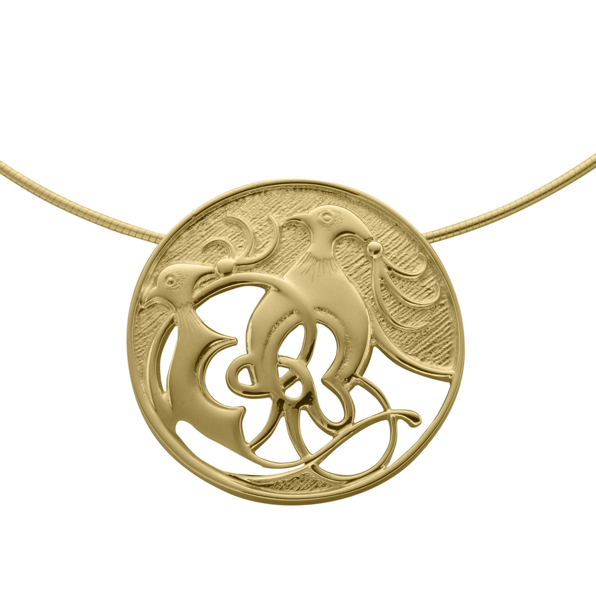 A gold circular pendant with intricate design of two birds