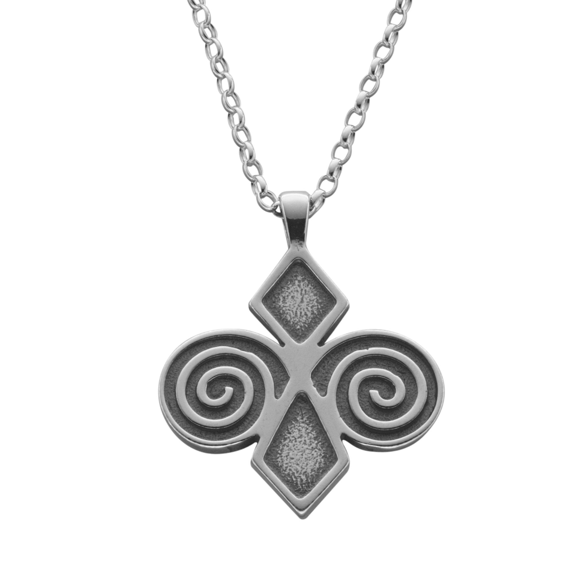 A silver necklace with a geometric designed pendant featuring diamond shapes and swirls
