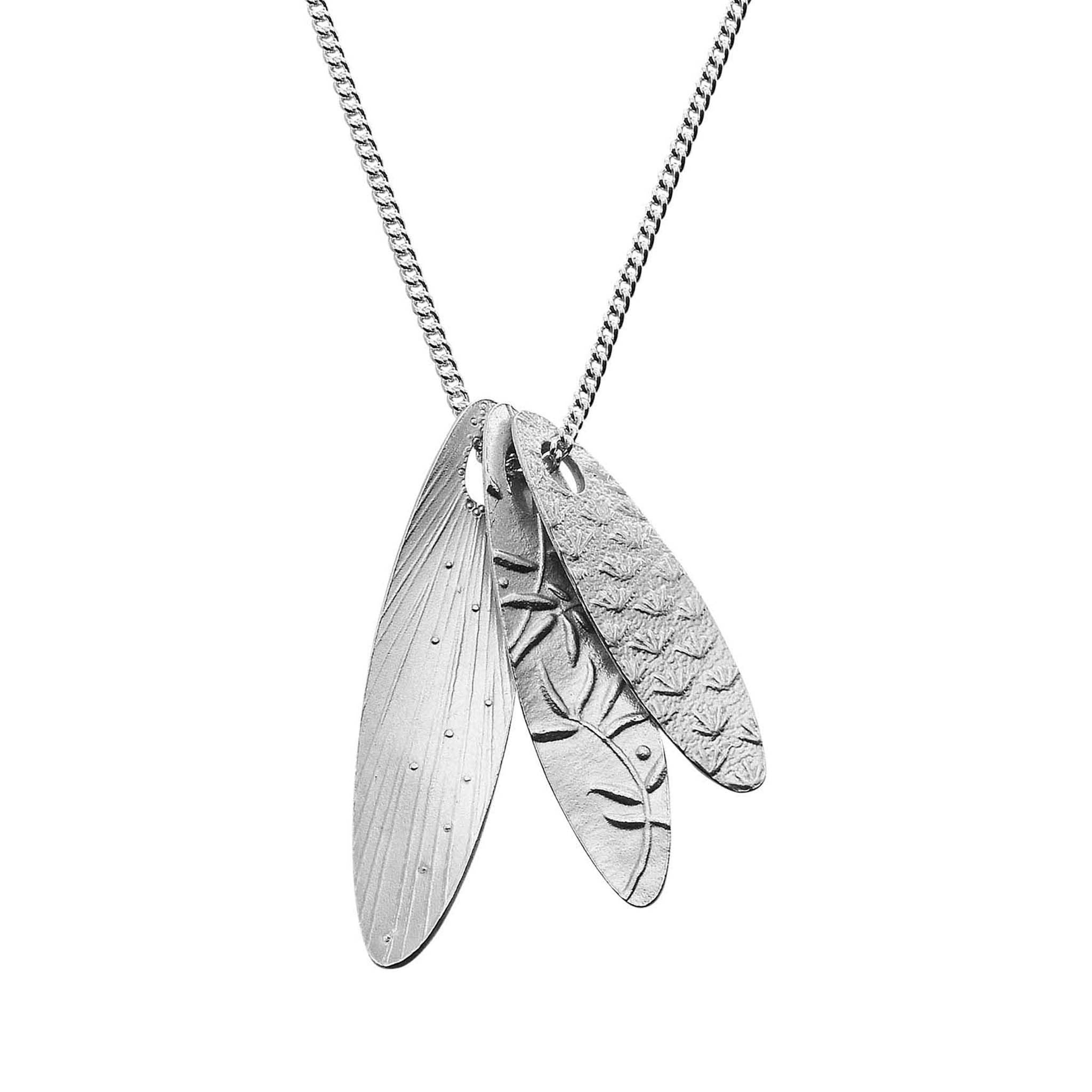 A silver pendant necklace featuring three leaf-shaped pendants that features plant designs.