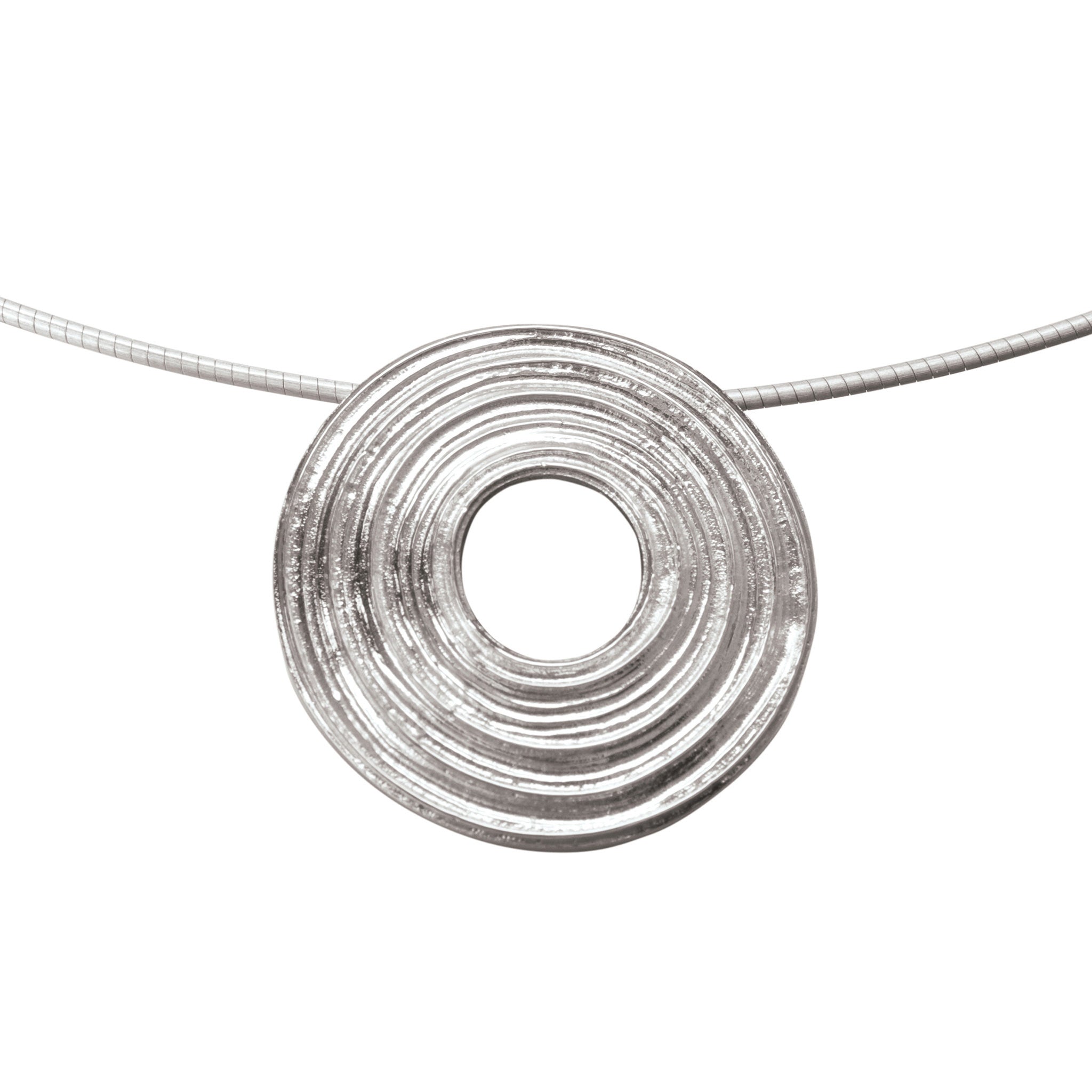 A silver necklace with a central circular patterned pendant