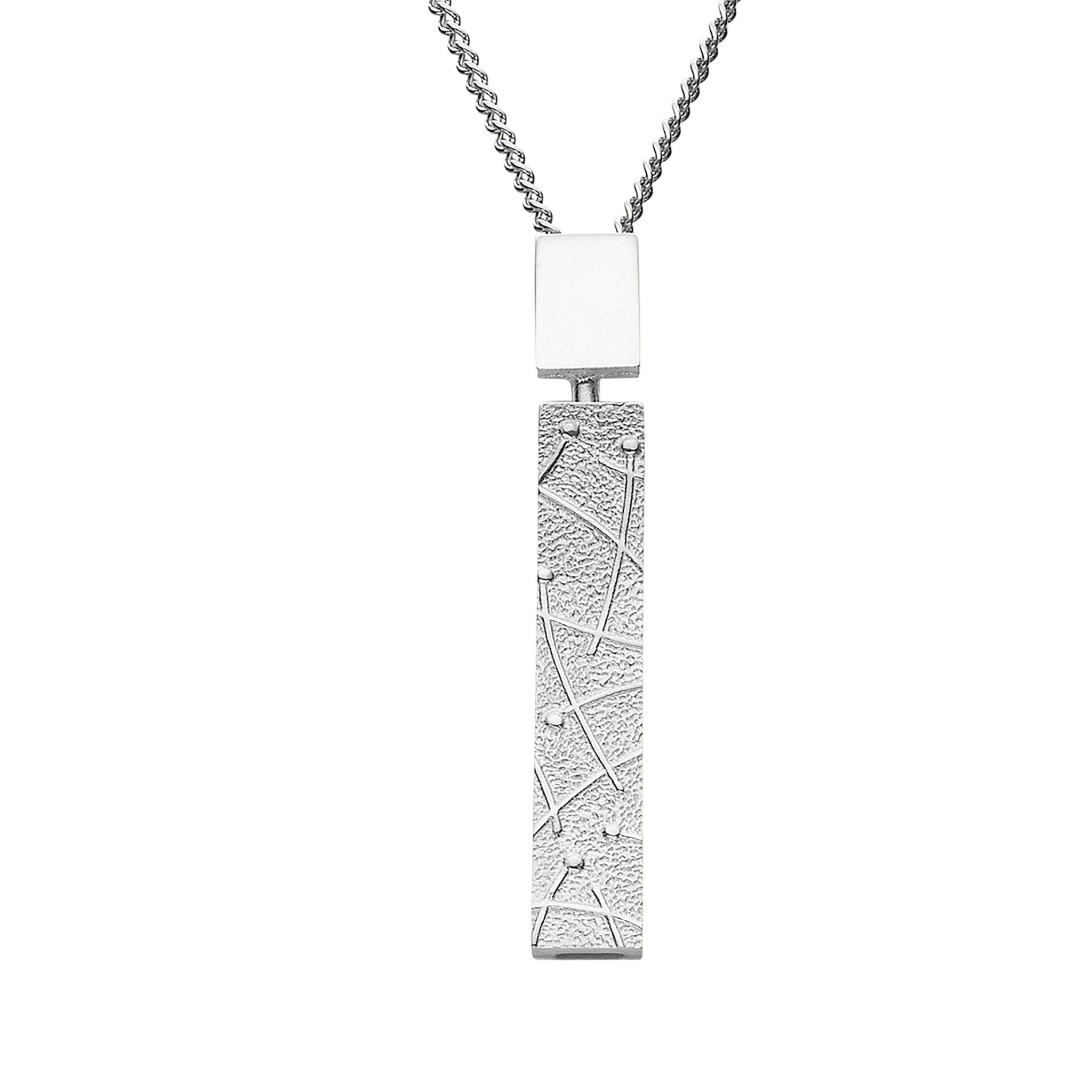 A silver necklace with a drop rectangular pendant with geometric lined design