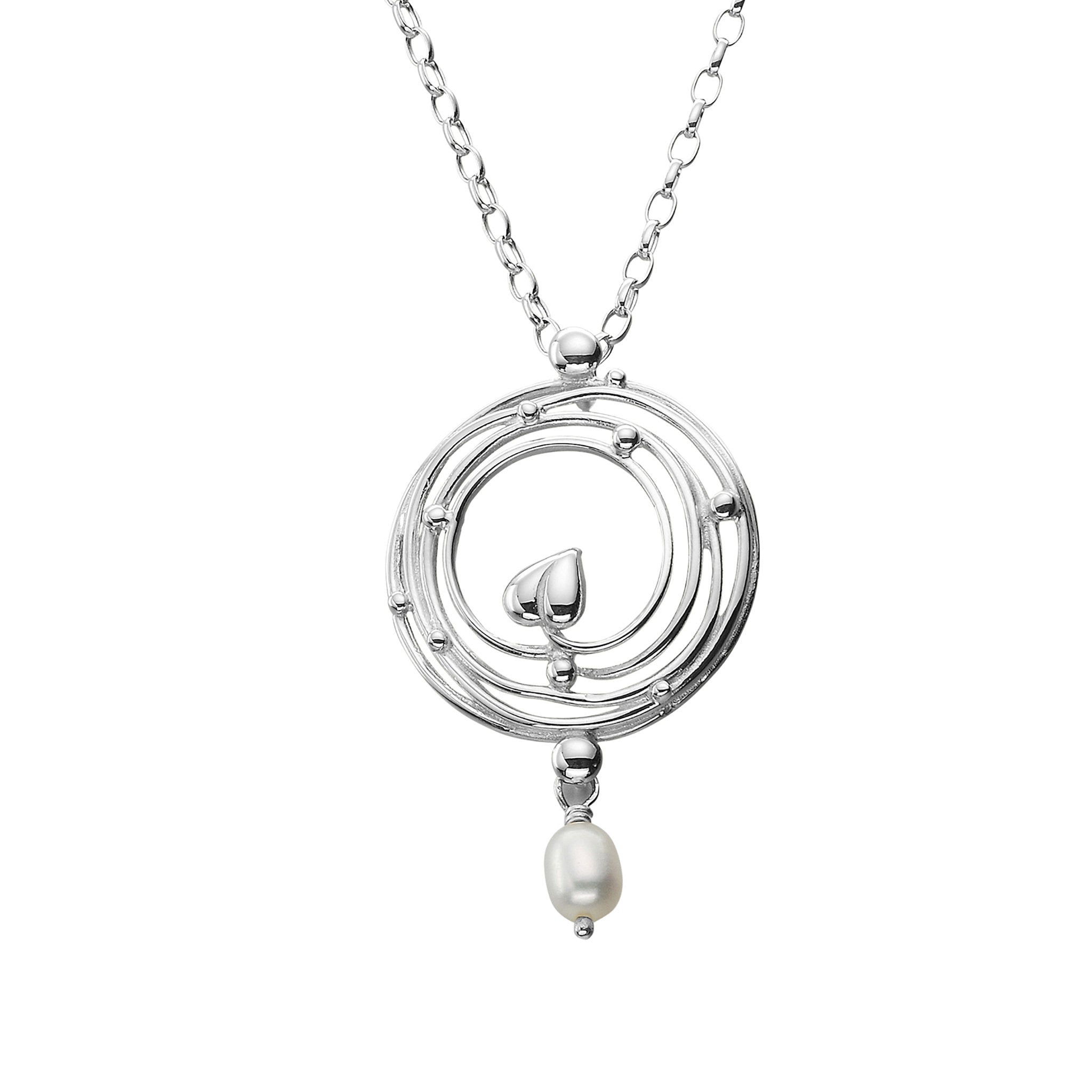 A silver necklace with a round pendant featuring a circular design of stems and little leaves with a drop pearl to finish it off