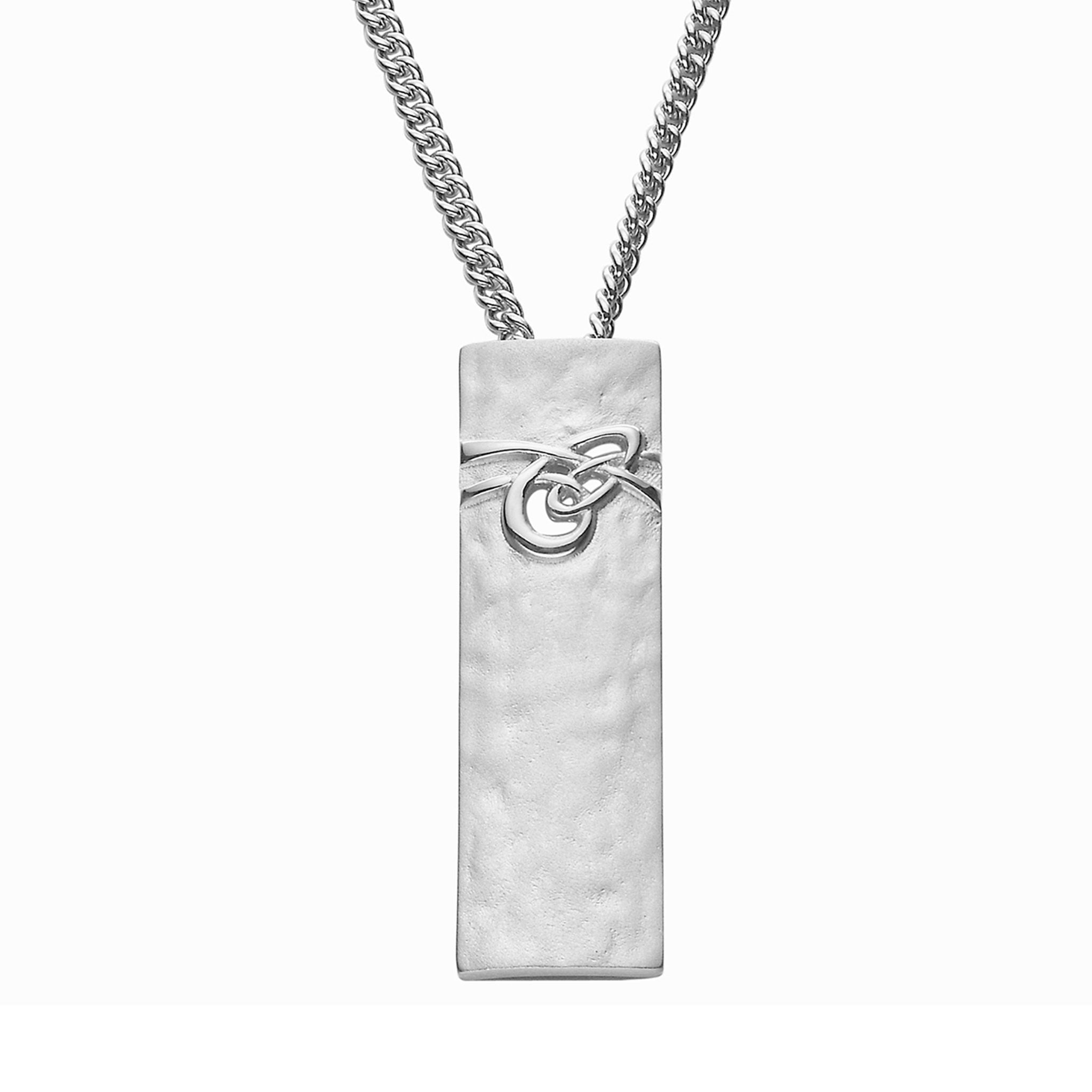 A silver necklace with a silver rectangular drop pendant with a knotted pattern