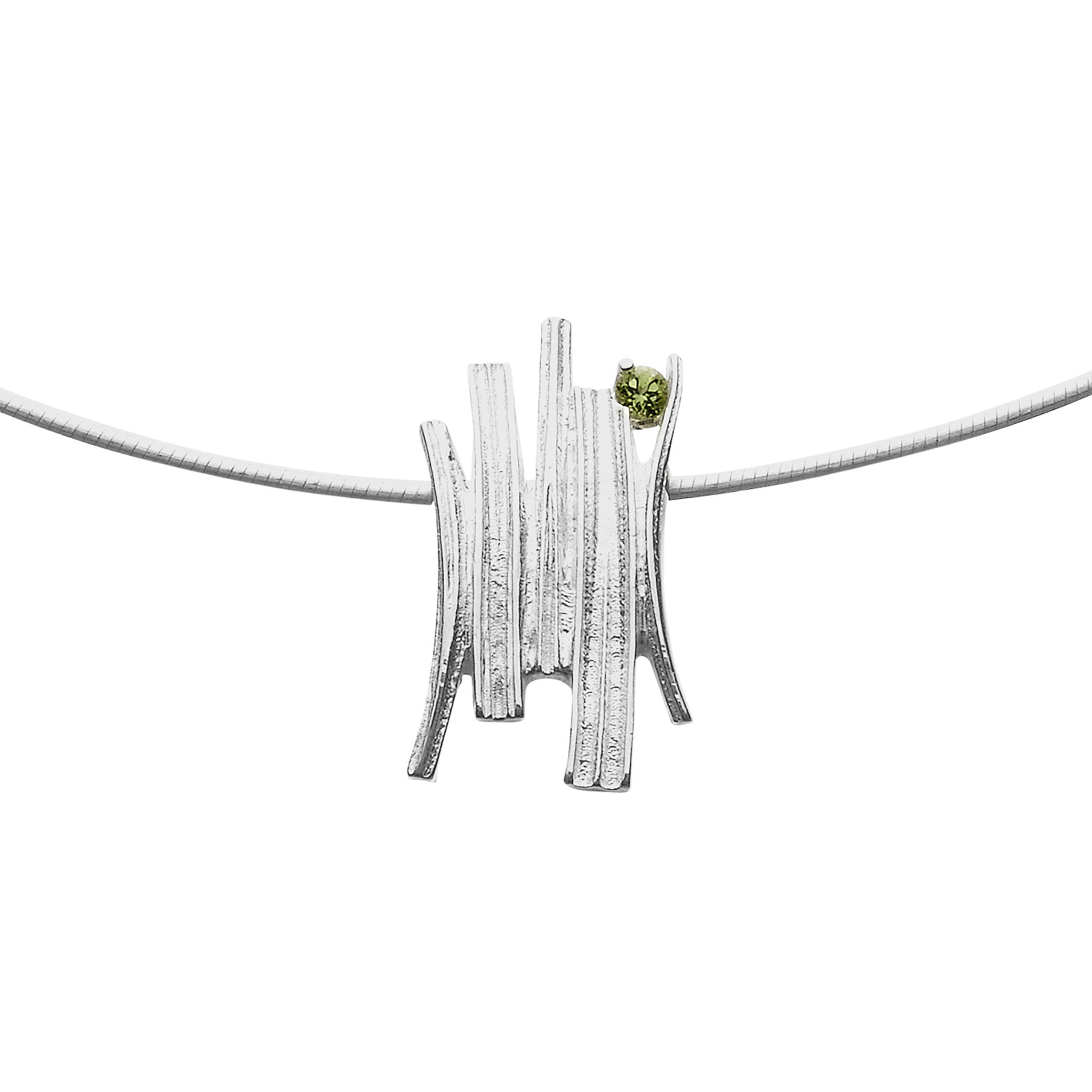 A silver necklace with a pendant that has a grass like design finished with a green gem stone