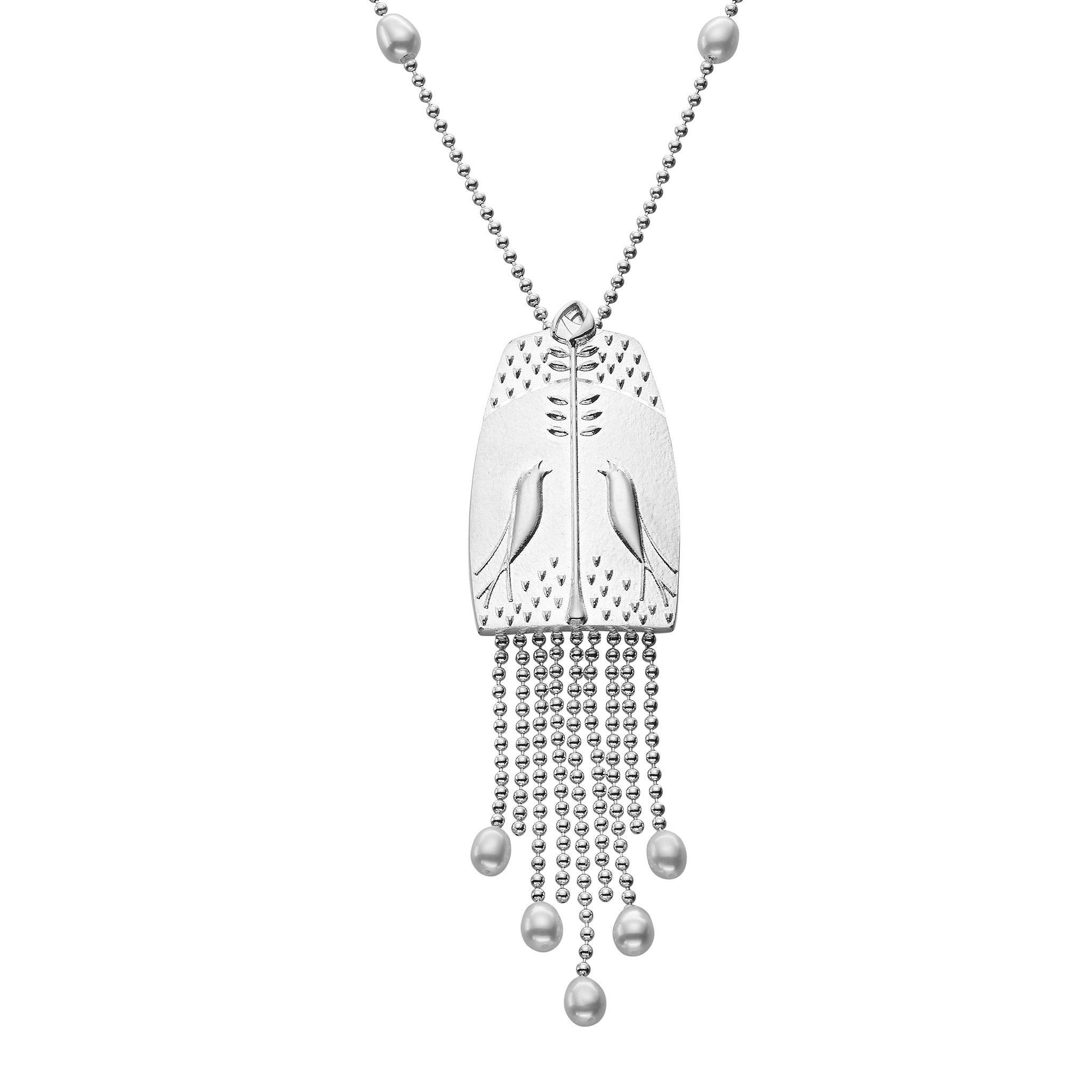 A silver necklace with a large silver pendant featuring bird and flower pattern with delicate chains hanging from the bottom with pearls