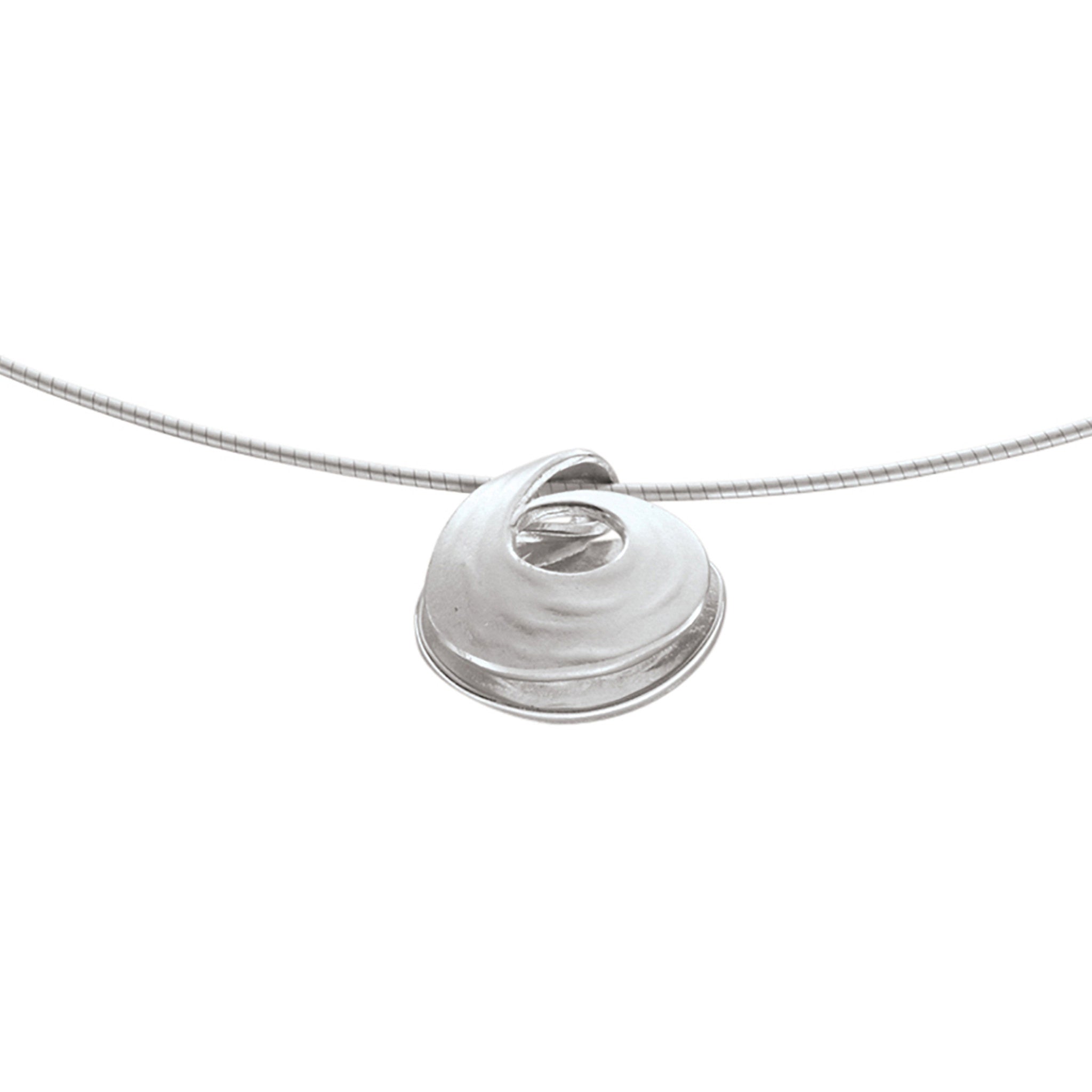 A small silver pendant with a single  swirl representing pools of water in strong currents