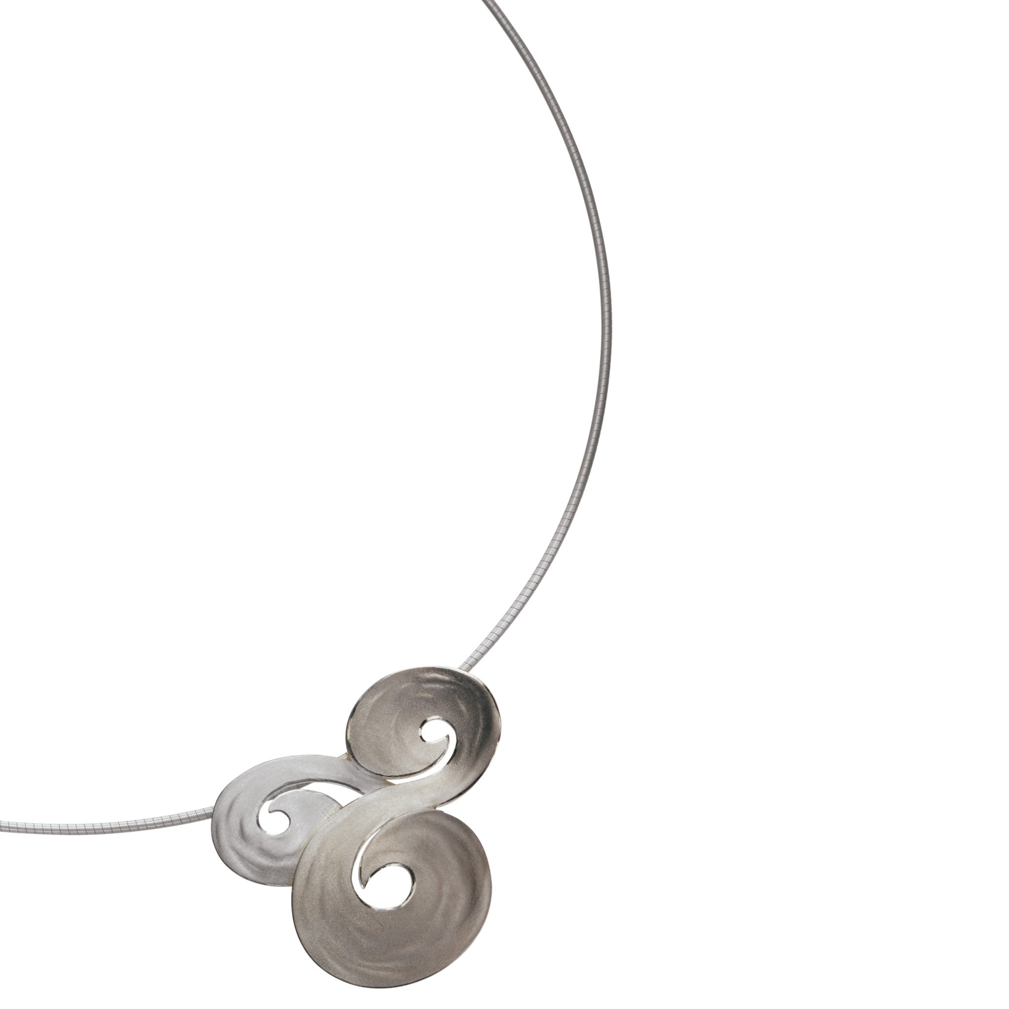 A silver pendant with three swirls representing pools of water in strong currents