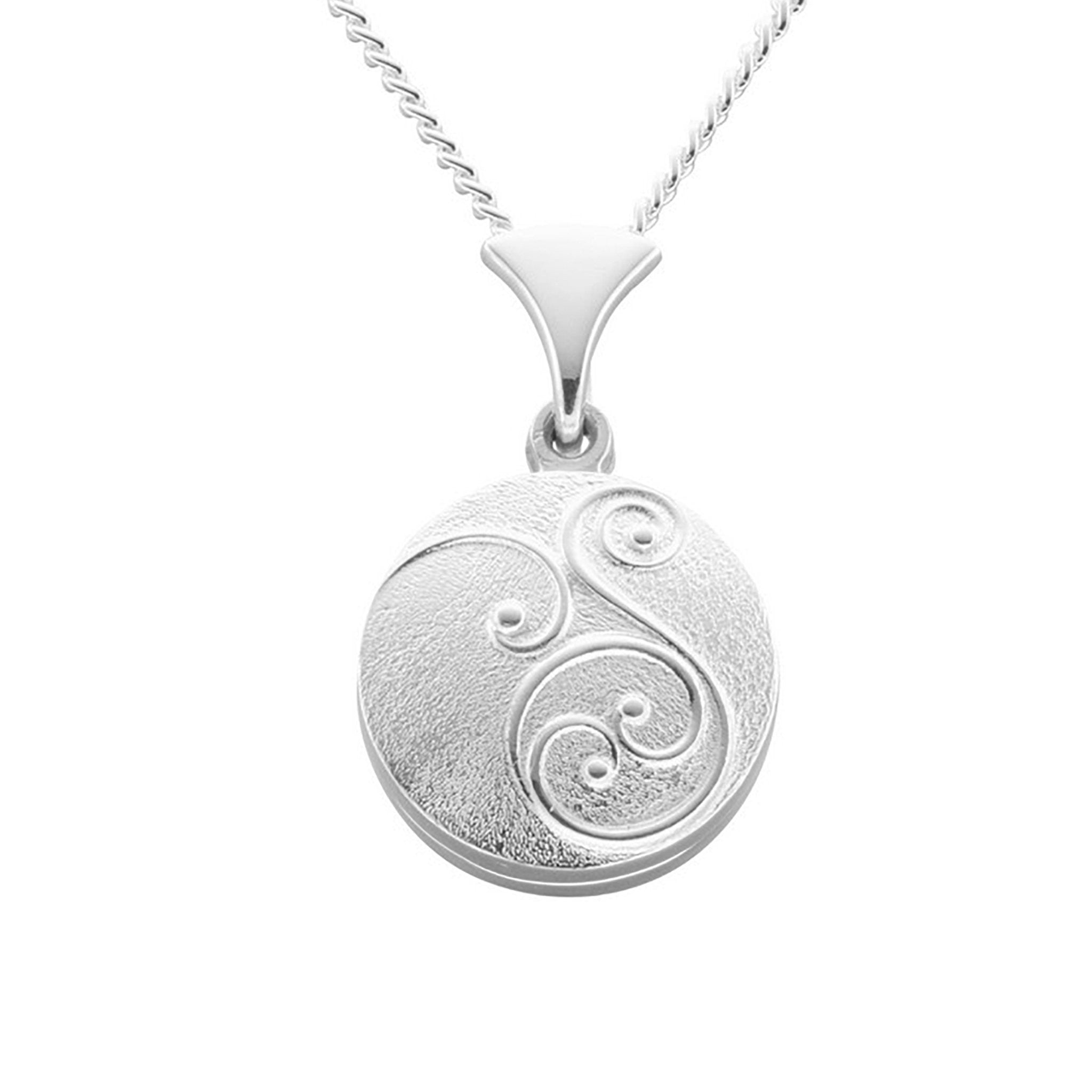 A silver necklace with an round pendant that has a simple geometric pattern