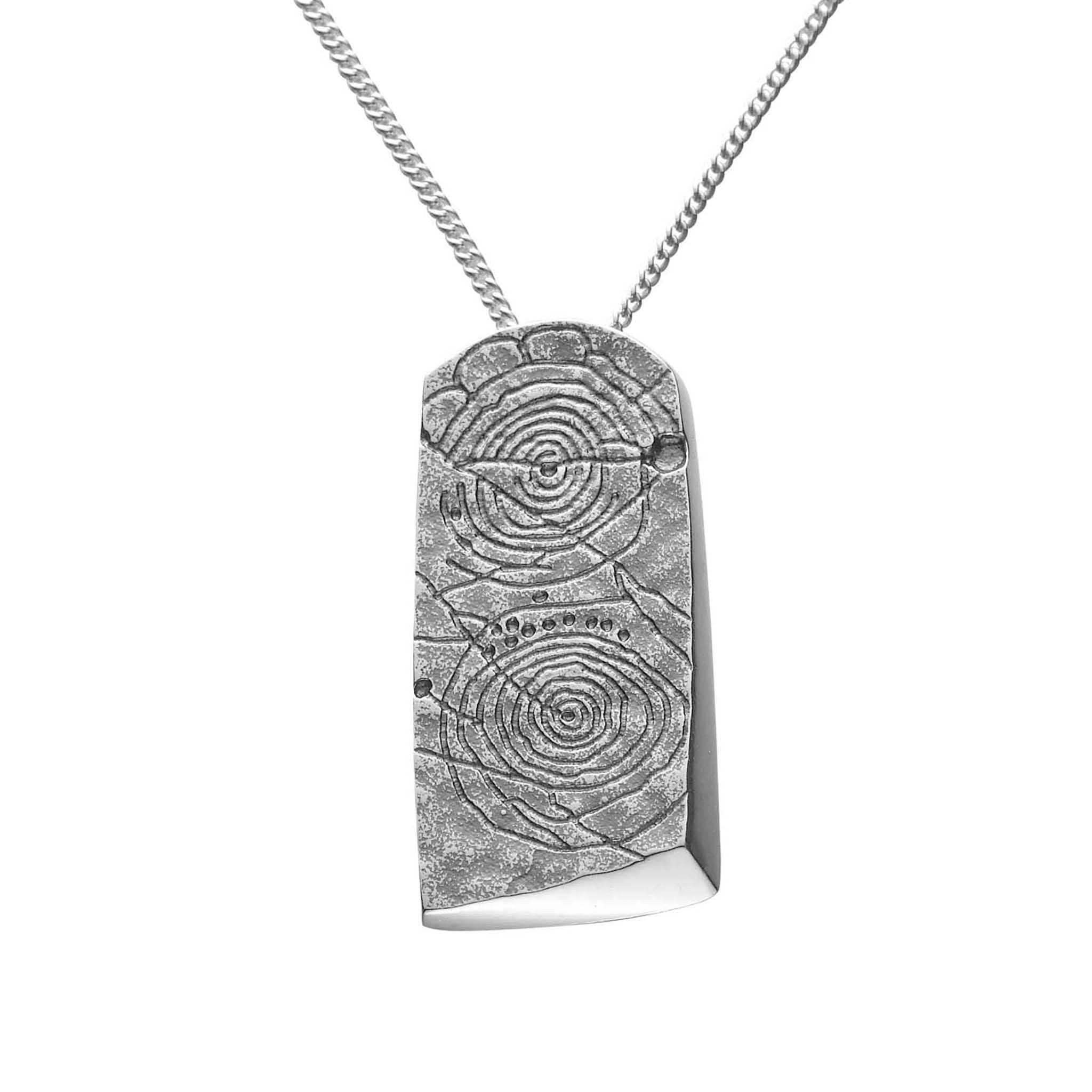 A large rectangular silver pendant with a geometric pattern, suspended by a chain.